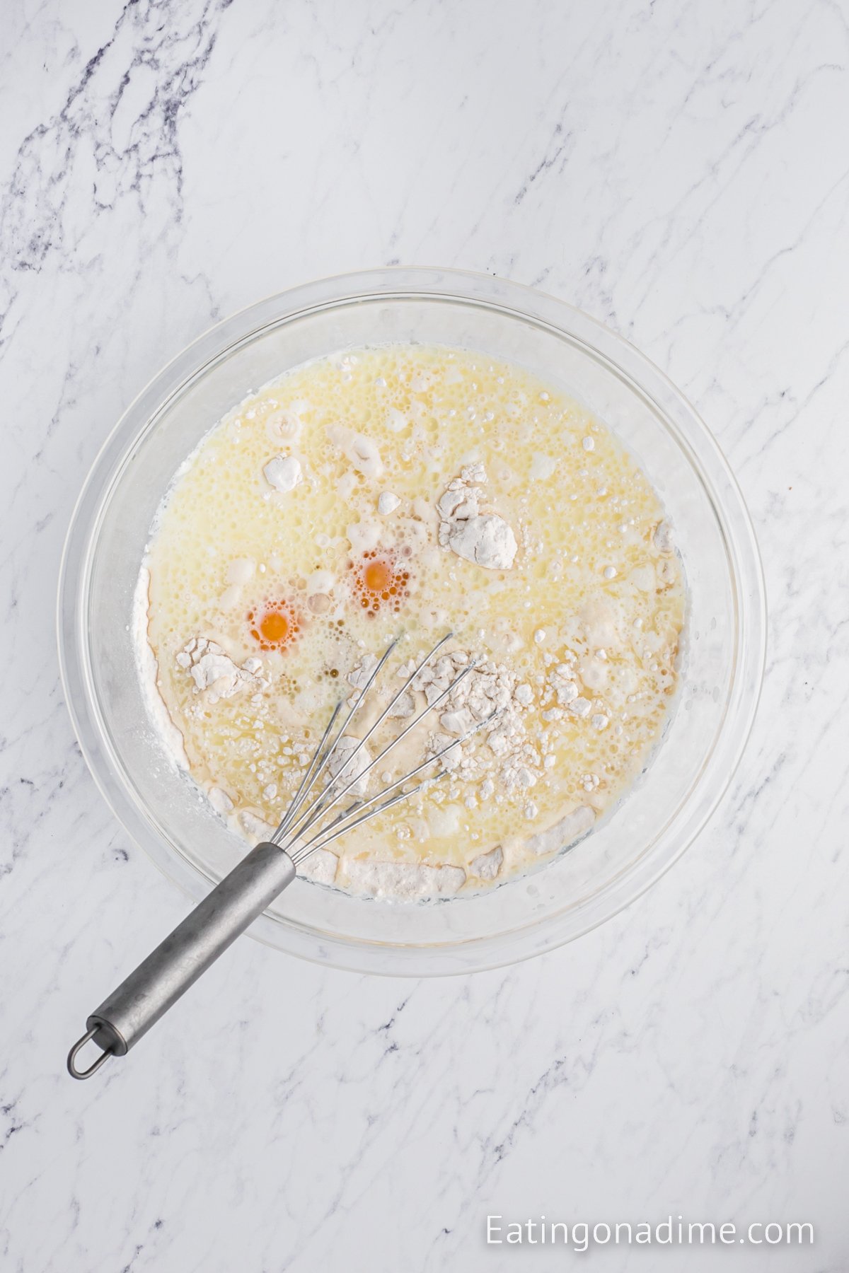 Bowl with batter being mixed. 