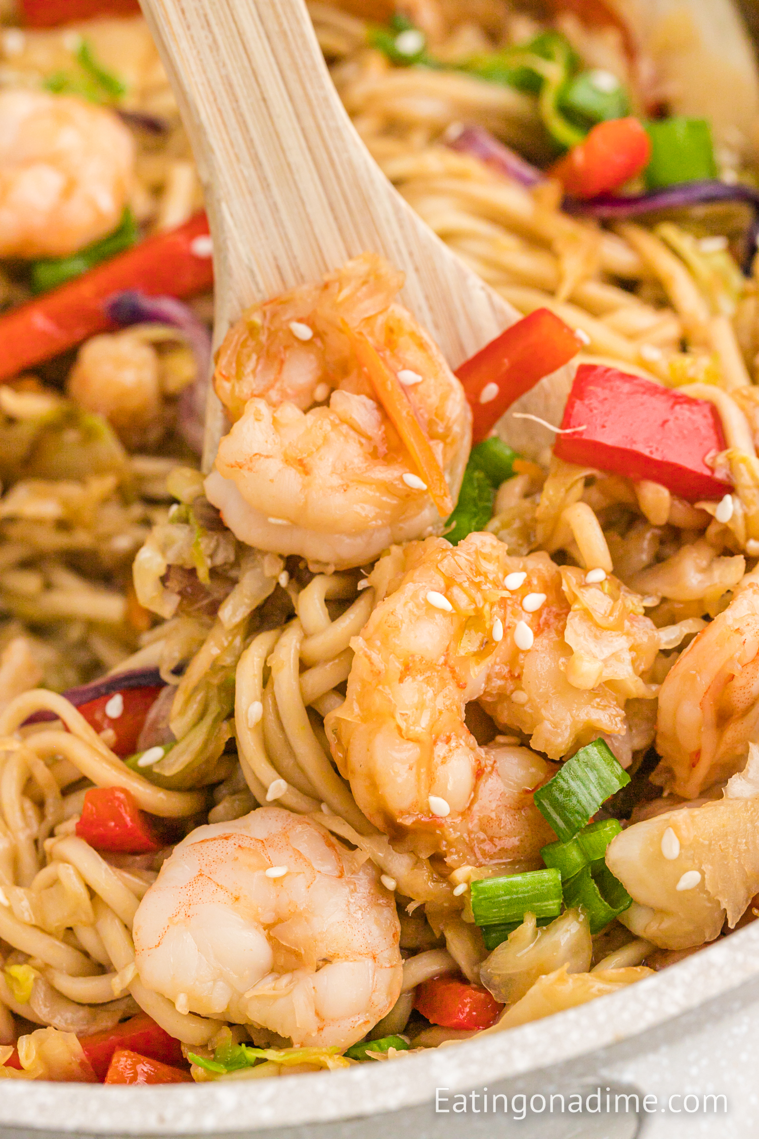 Shrimp Lo Mein in a bowl with a wooden spoon