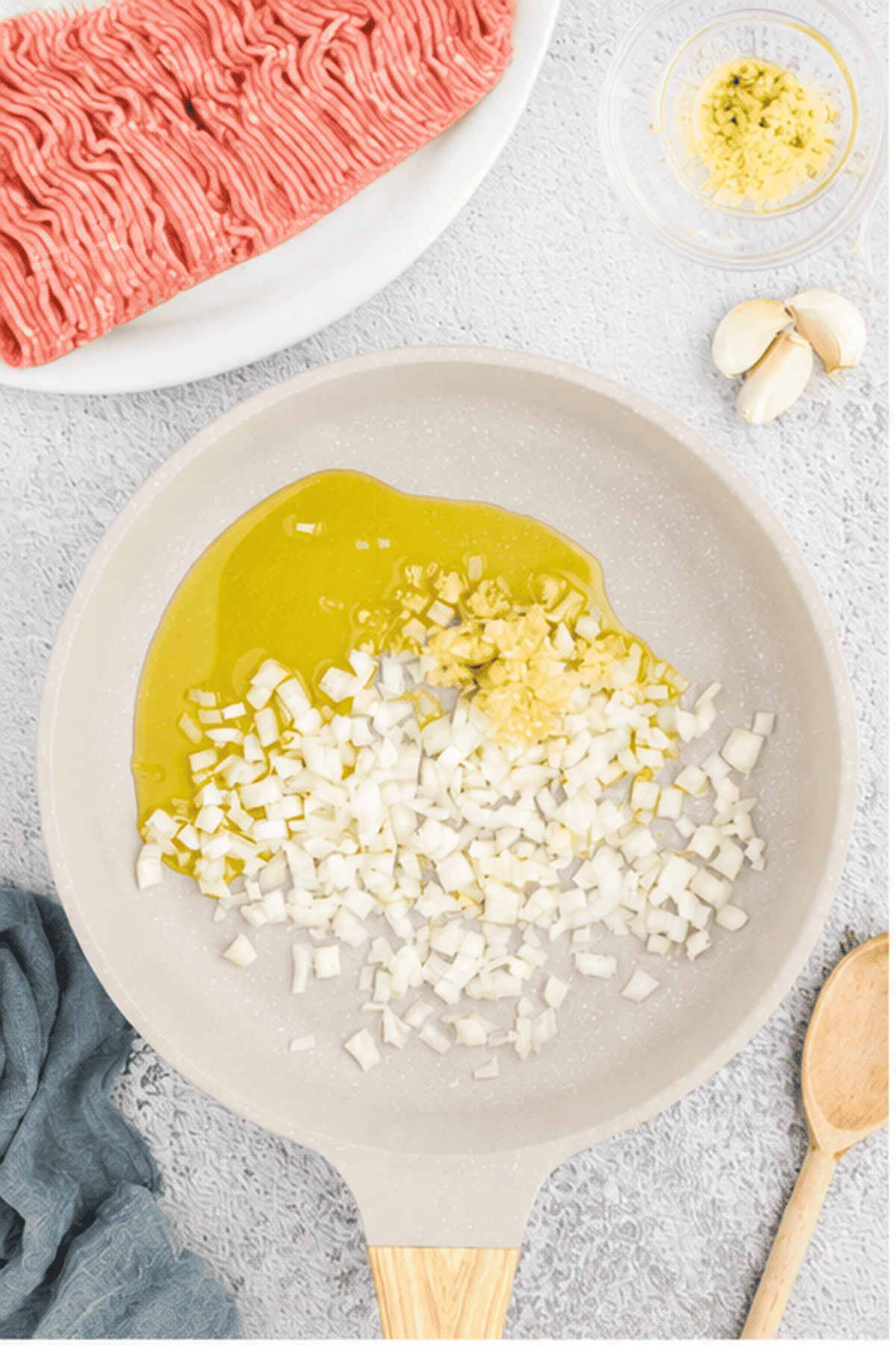 Diced onions and minced garlic cooking in oil in a large skillet.