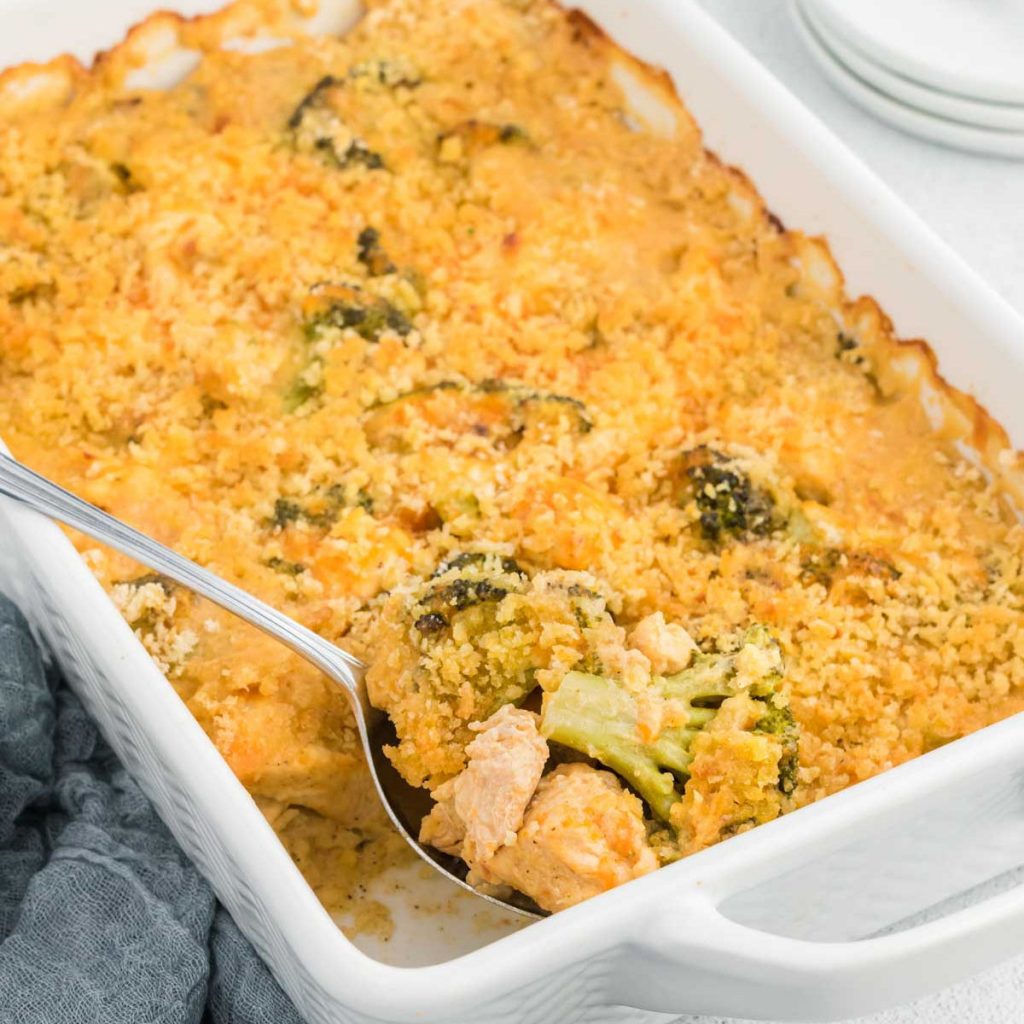 Chicken Divan Casserole in a baking dish with a serving on a spoon