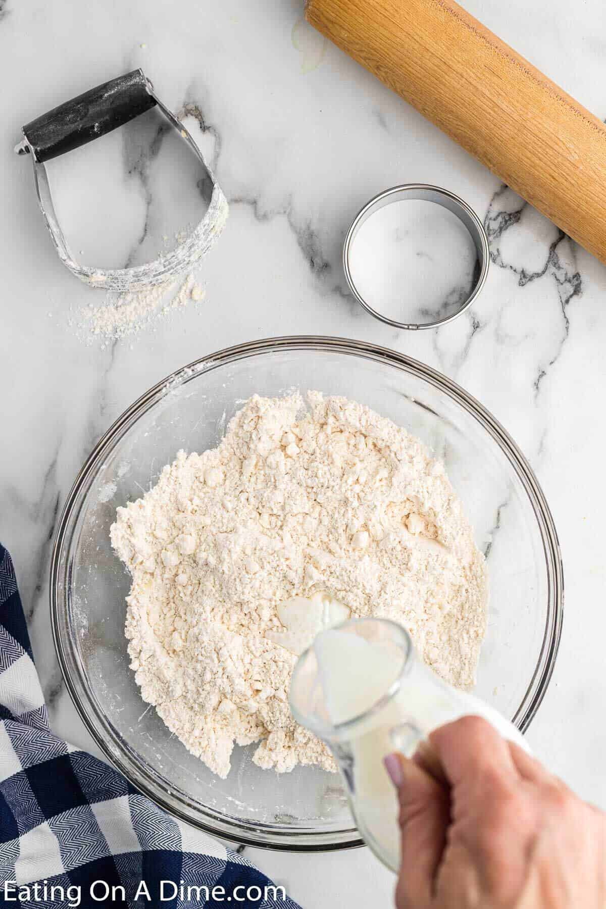 Pouring the buttermilk into the dry ingredients