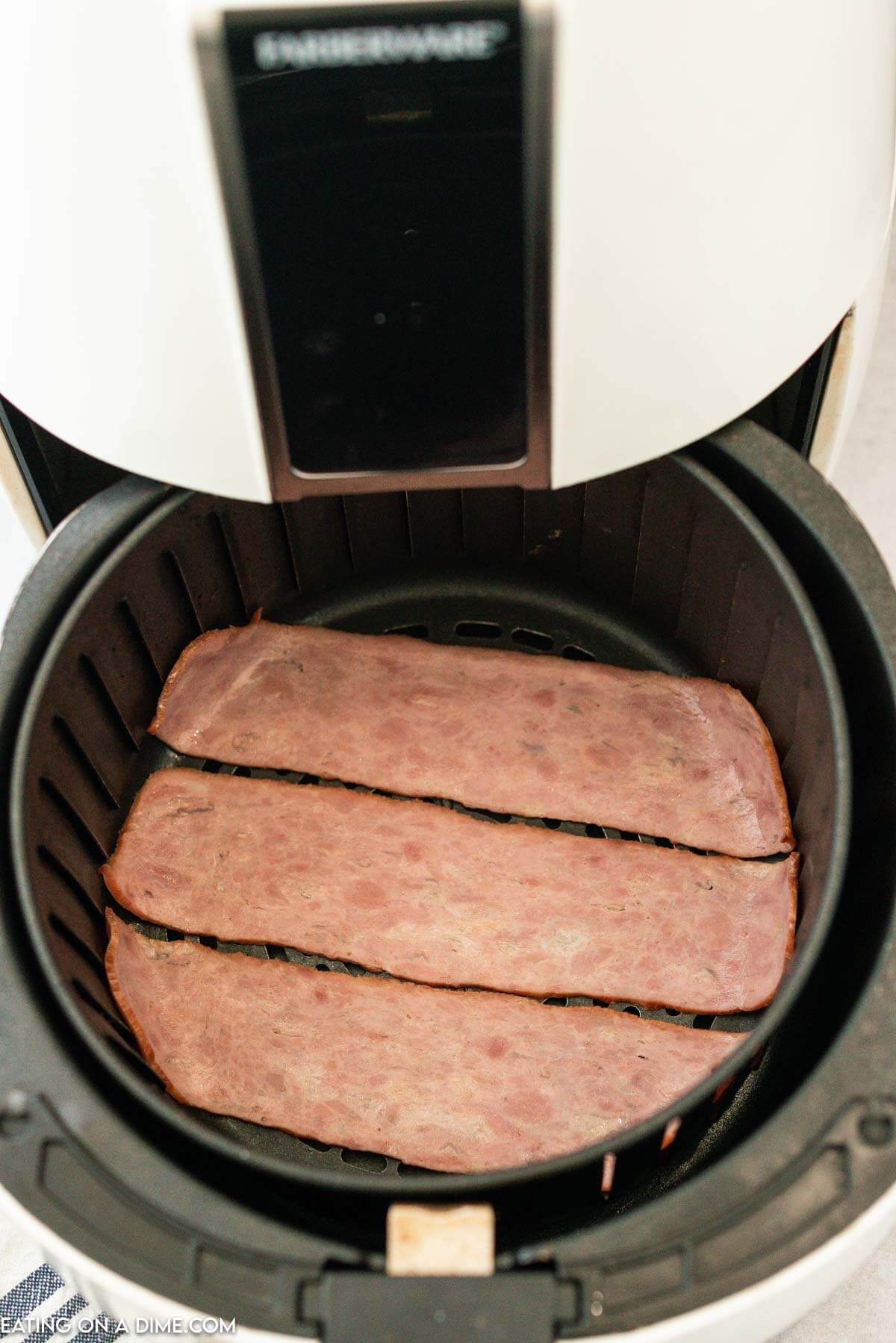 placing the turkey bacon in the air fryer
