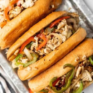 Close up of Chicken Philly Sandwiches on a silver serving platter.