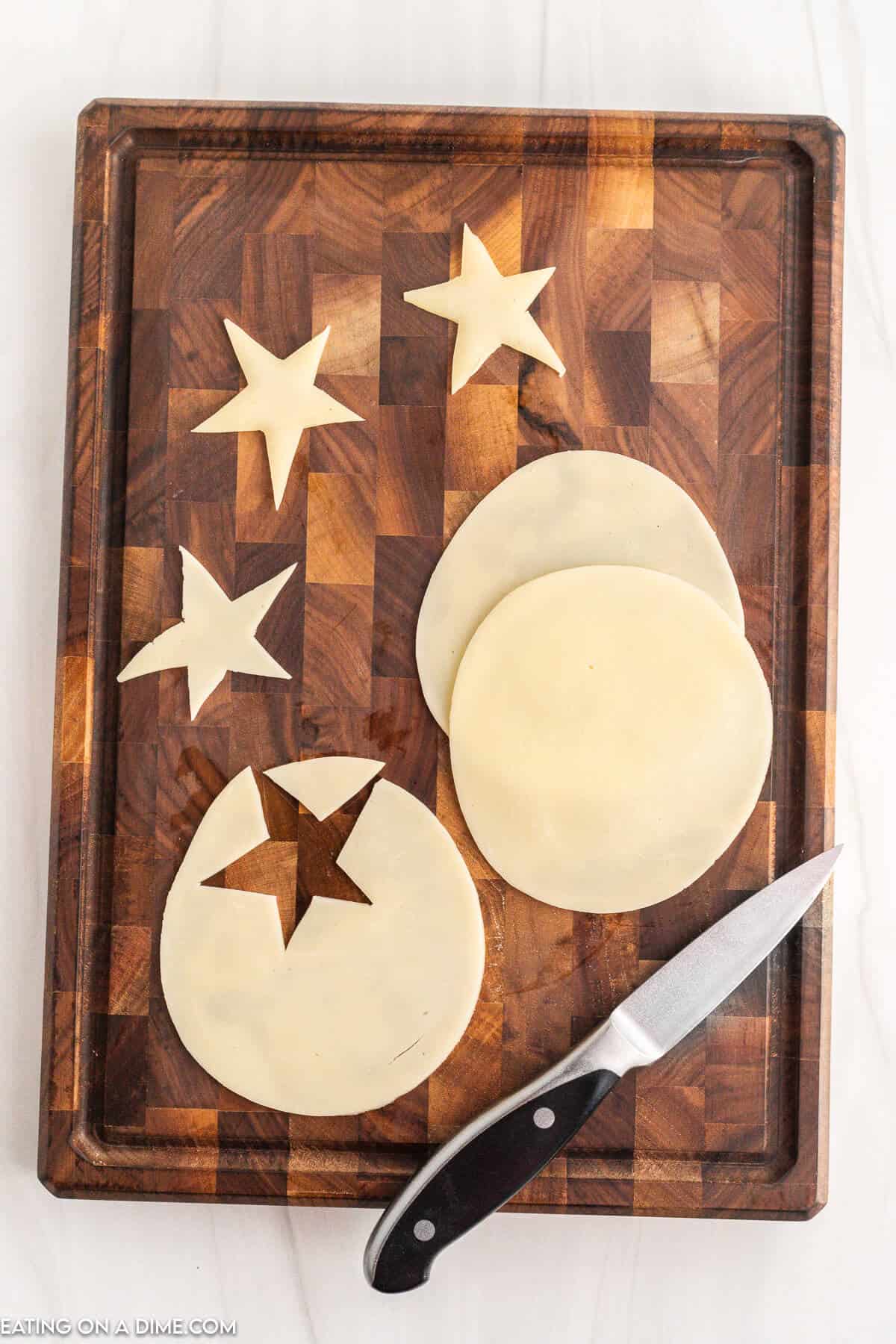 Cheese on cutting board with star shapes. 