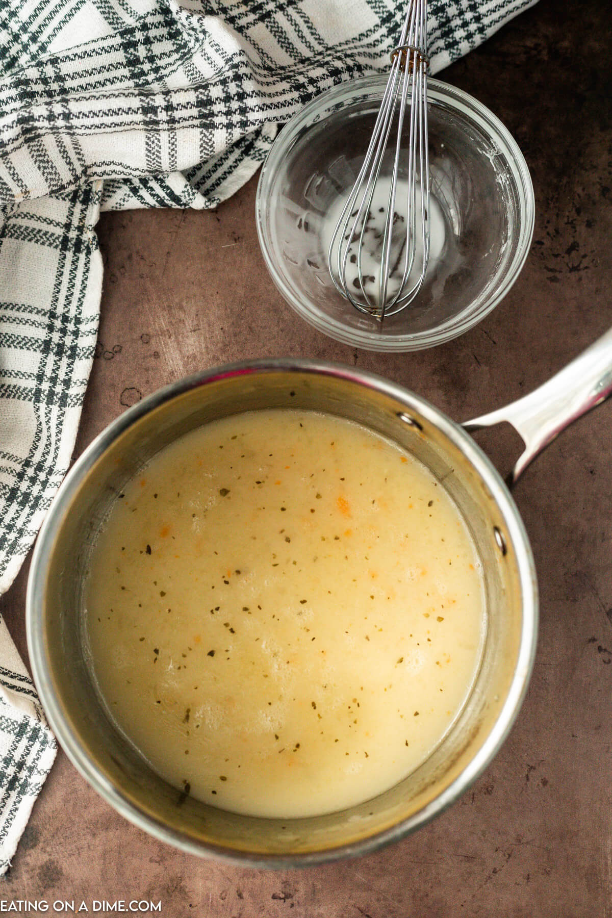 The cornstarch mixture whisked into the saucepan with the liquid from the crock pot.  