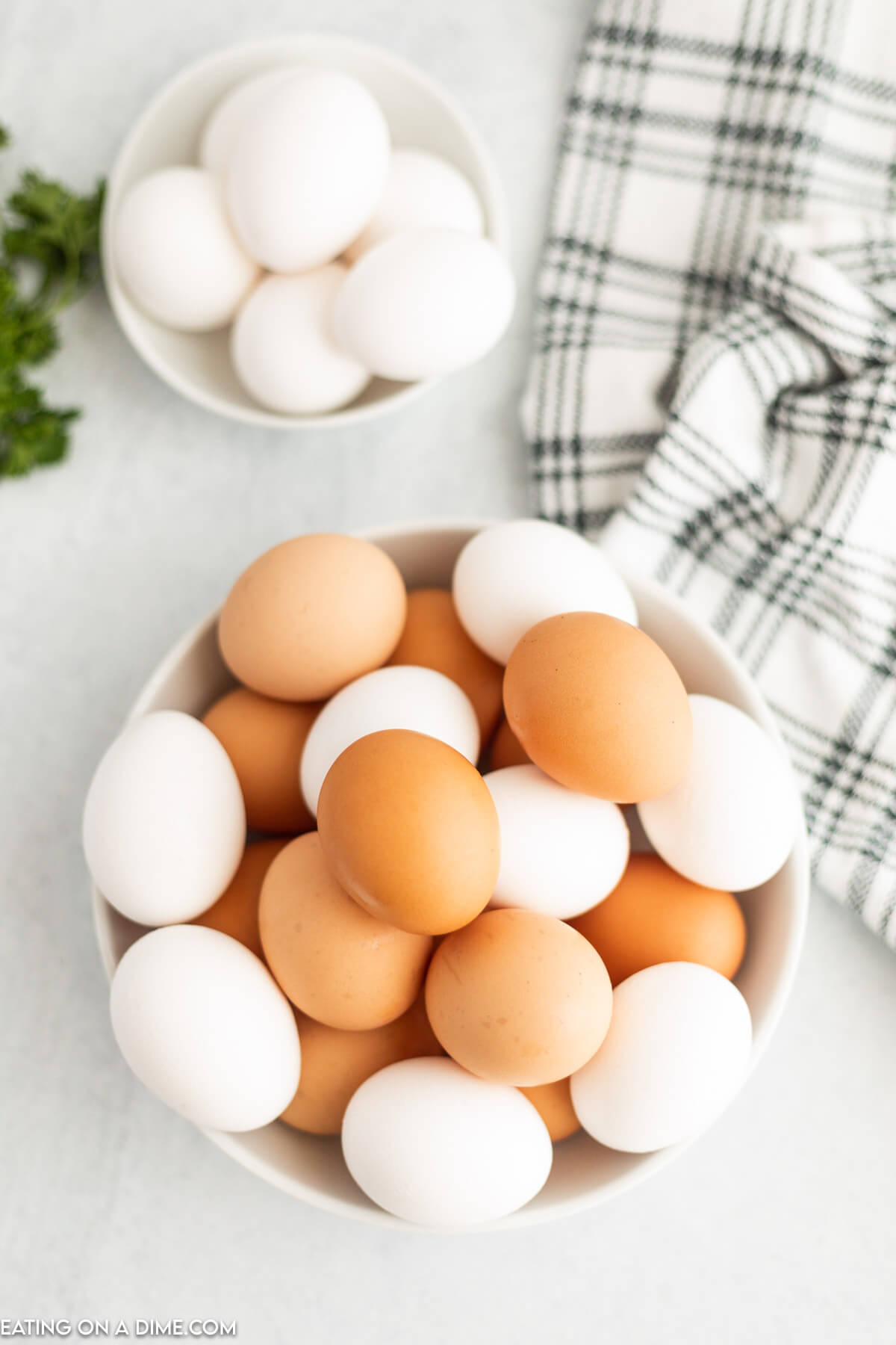 Brown and White eggs in a white bowl.