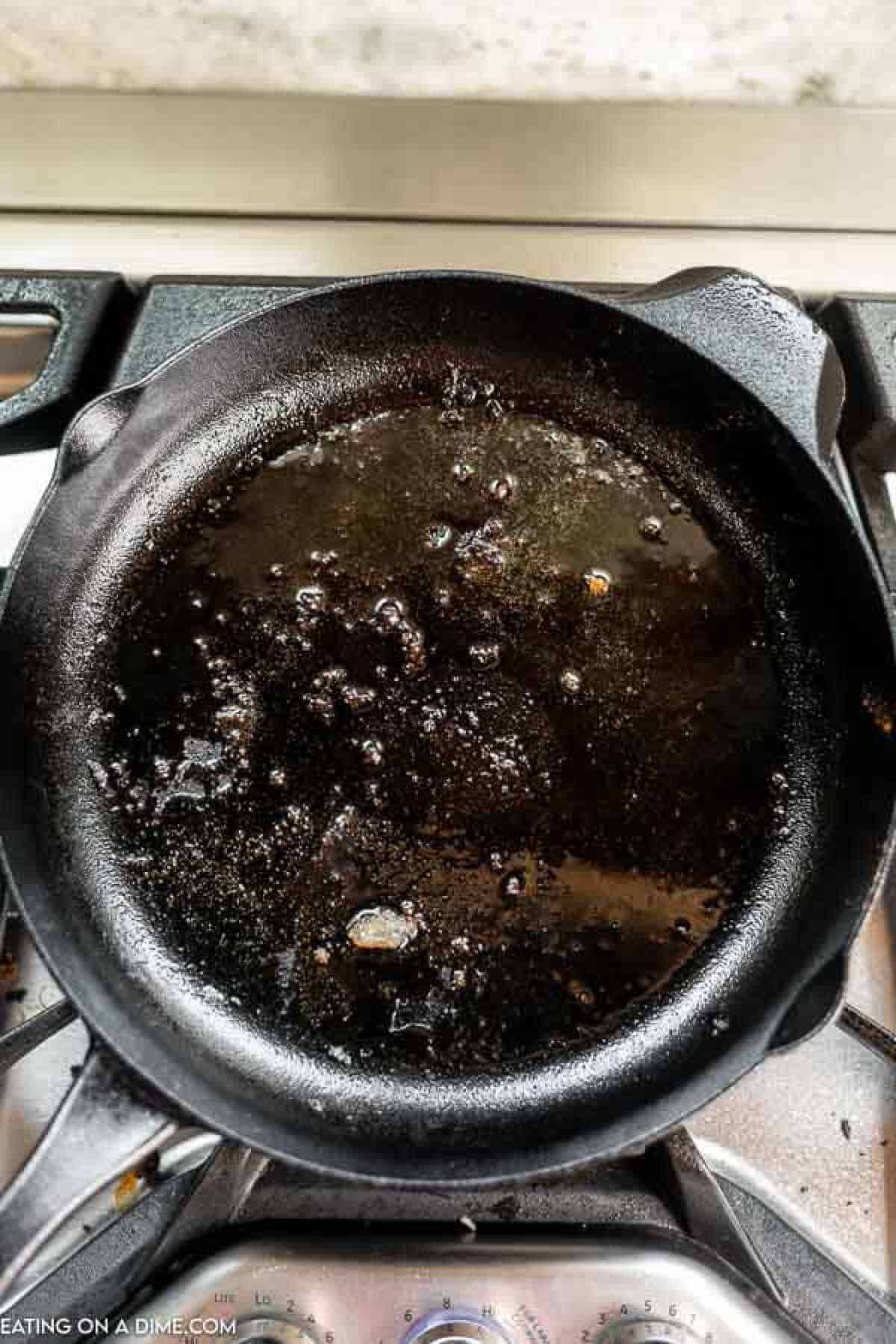 Cast Iron Skillet topped with oil on the stovetop