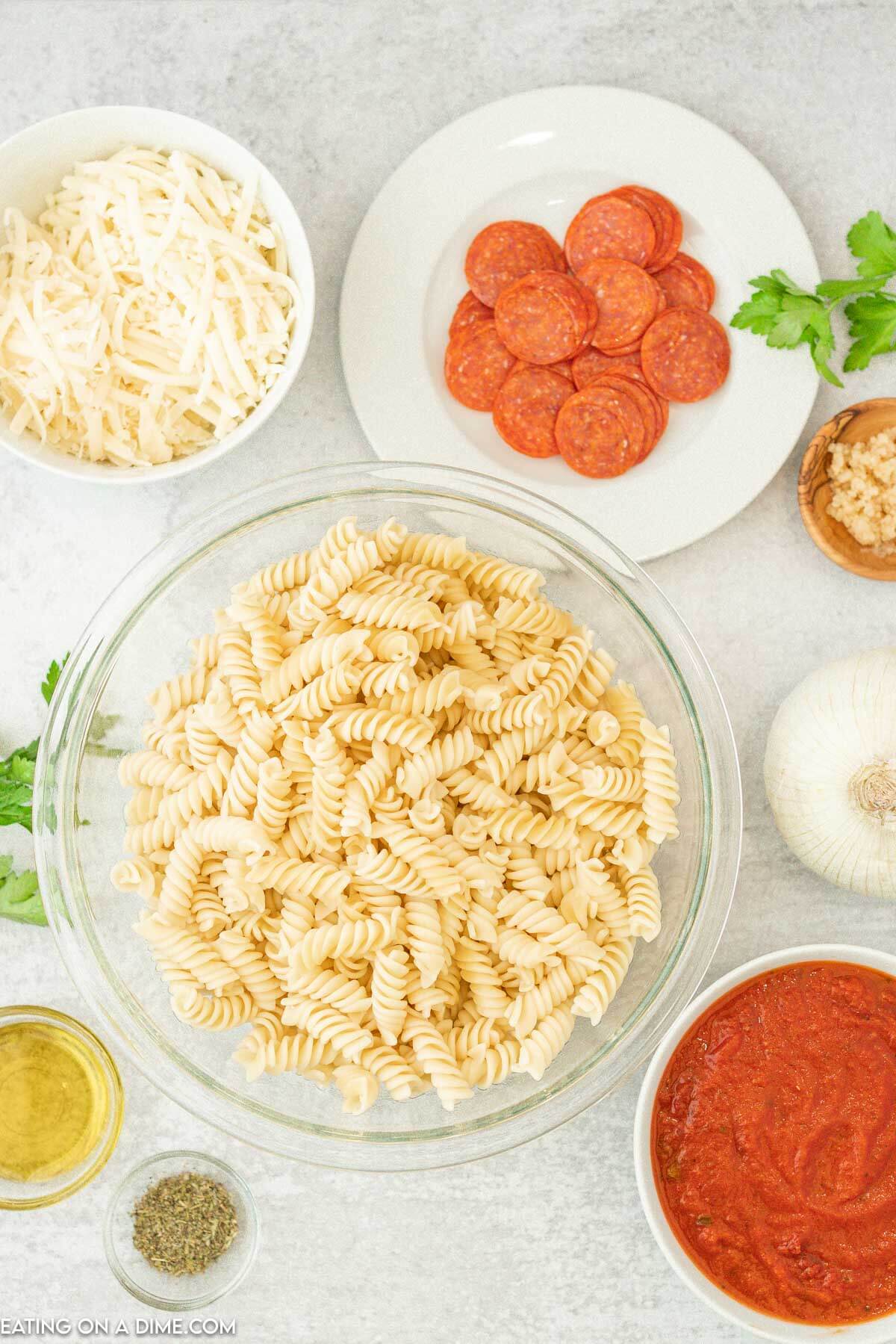 Ingredients needed - rotini pasta, olive oil, onion, pepperoni, minced garlic, italian seasoning, marinara sauce, water, mozzarella cheese, parmesan cheese, italian parsley