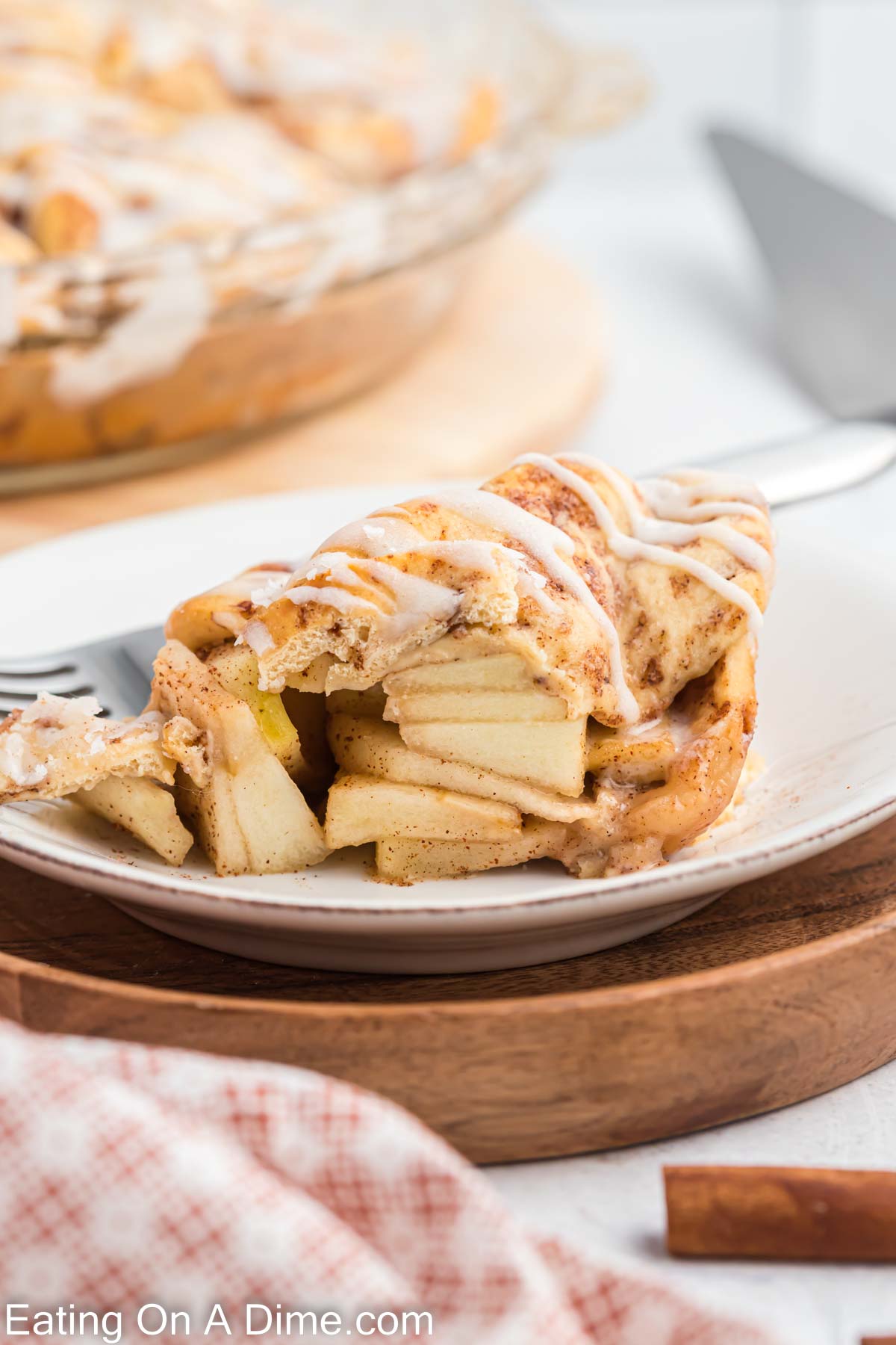 Cinnamon roll apple pie a slice on a plate