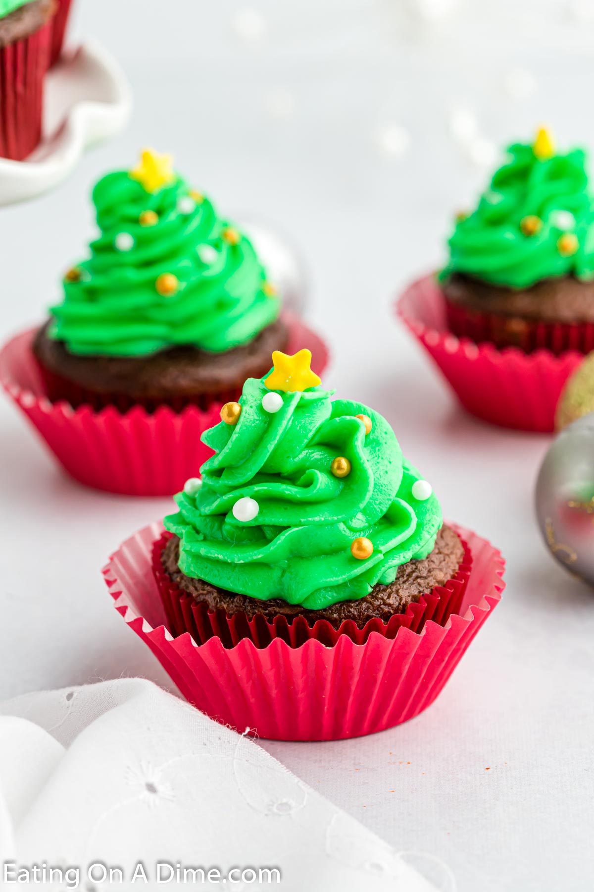 Christmas tree cupcakes in red liners. 
