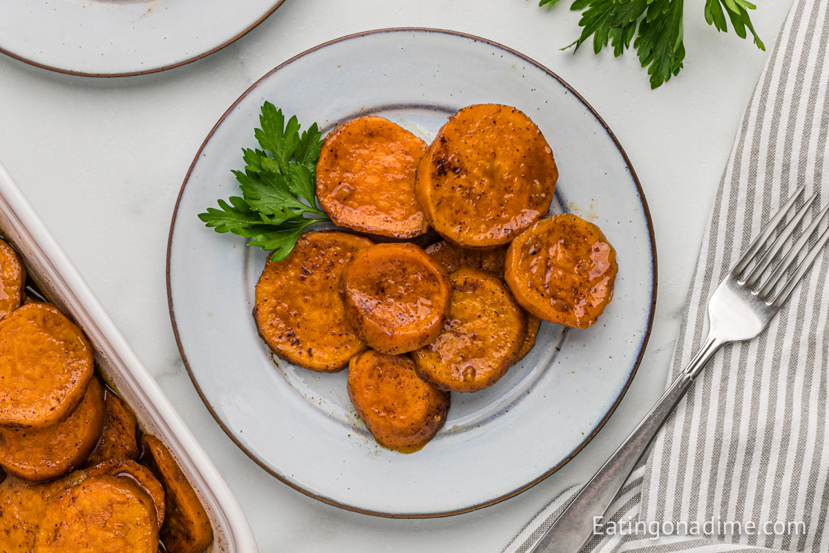 Candied sweet potatoes on a white plate