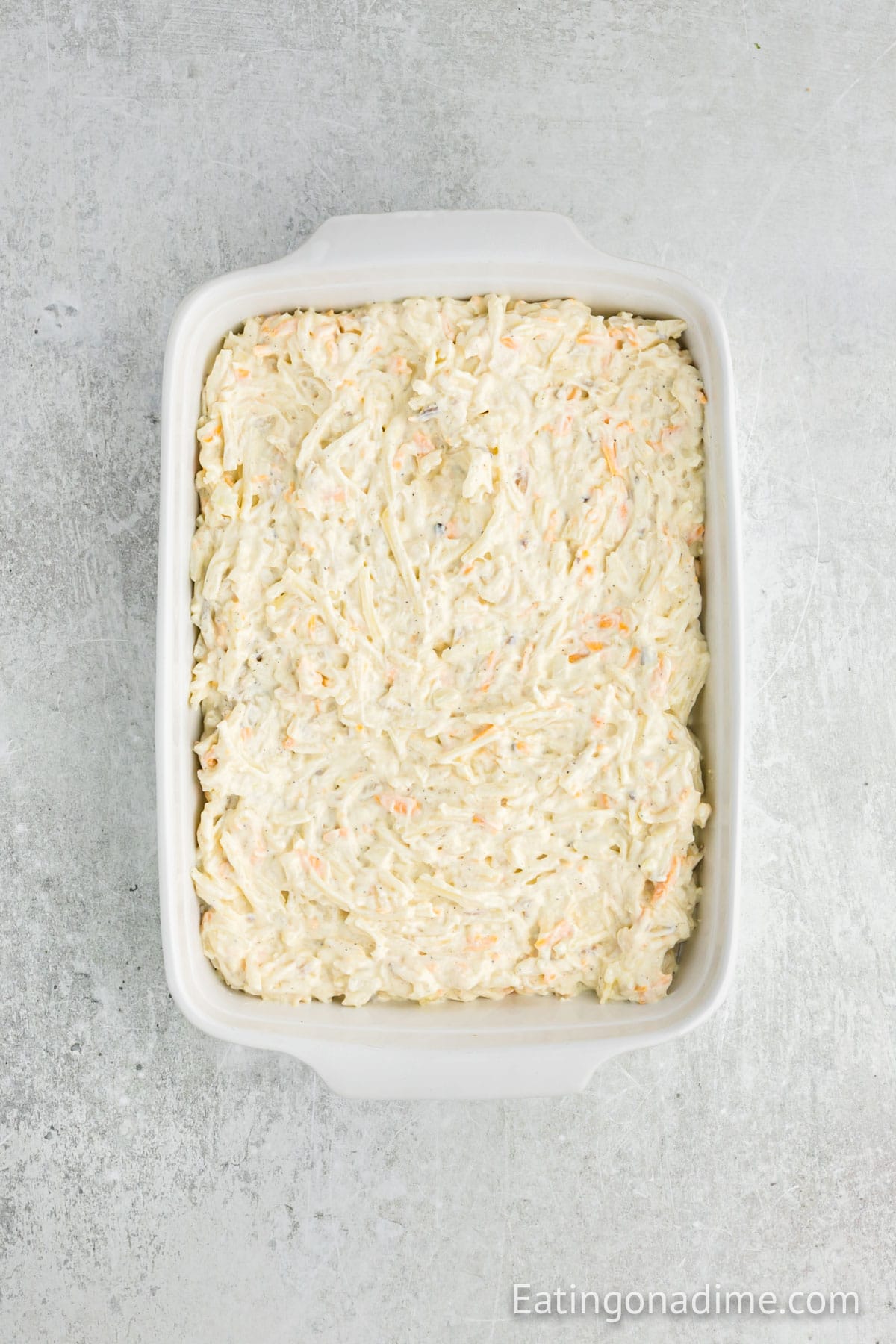 Spreading the hash brown casserole in a baking dish
