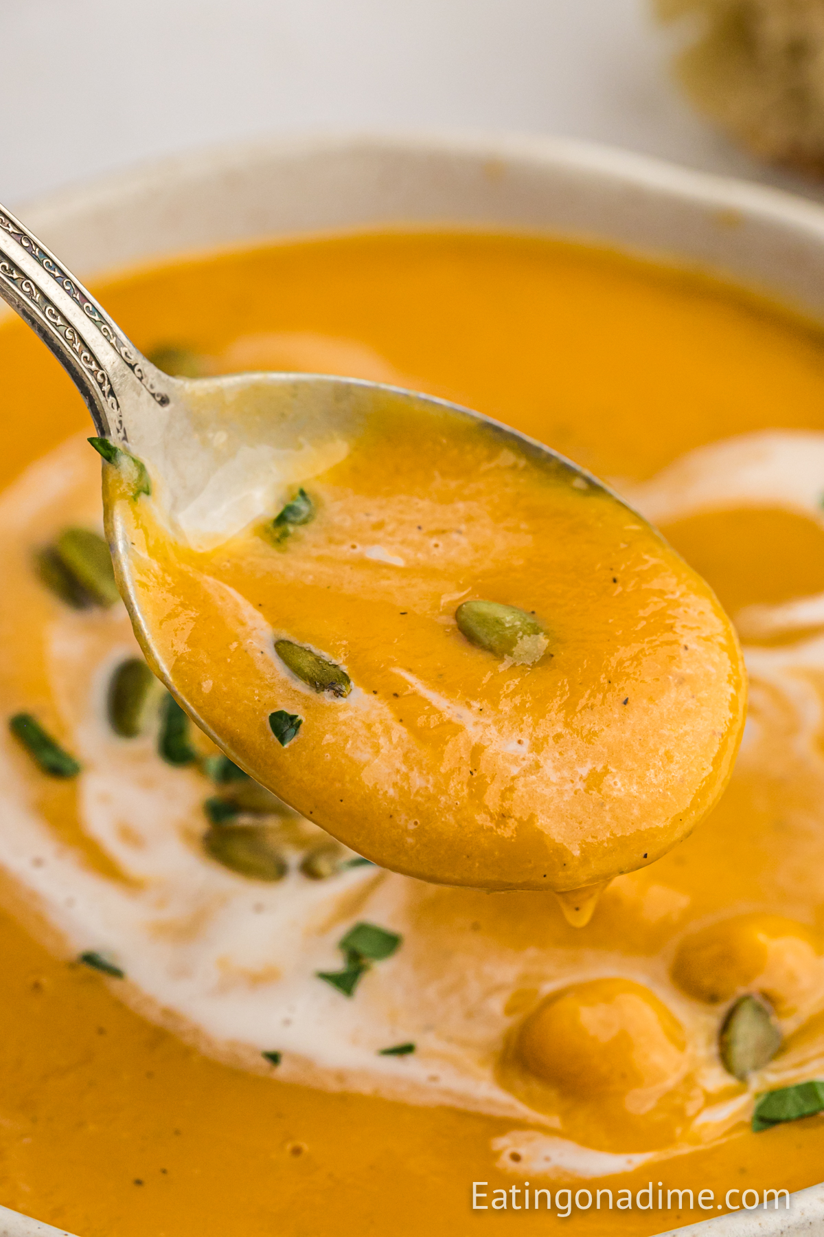 Sweet Potato Soup in the crock pot with a serving on a spoon