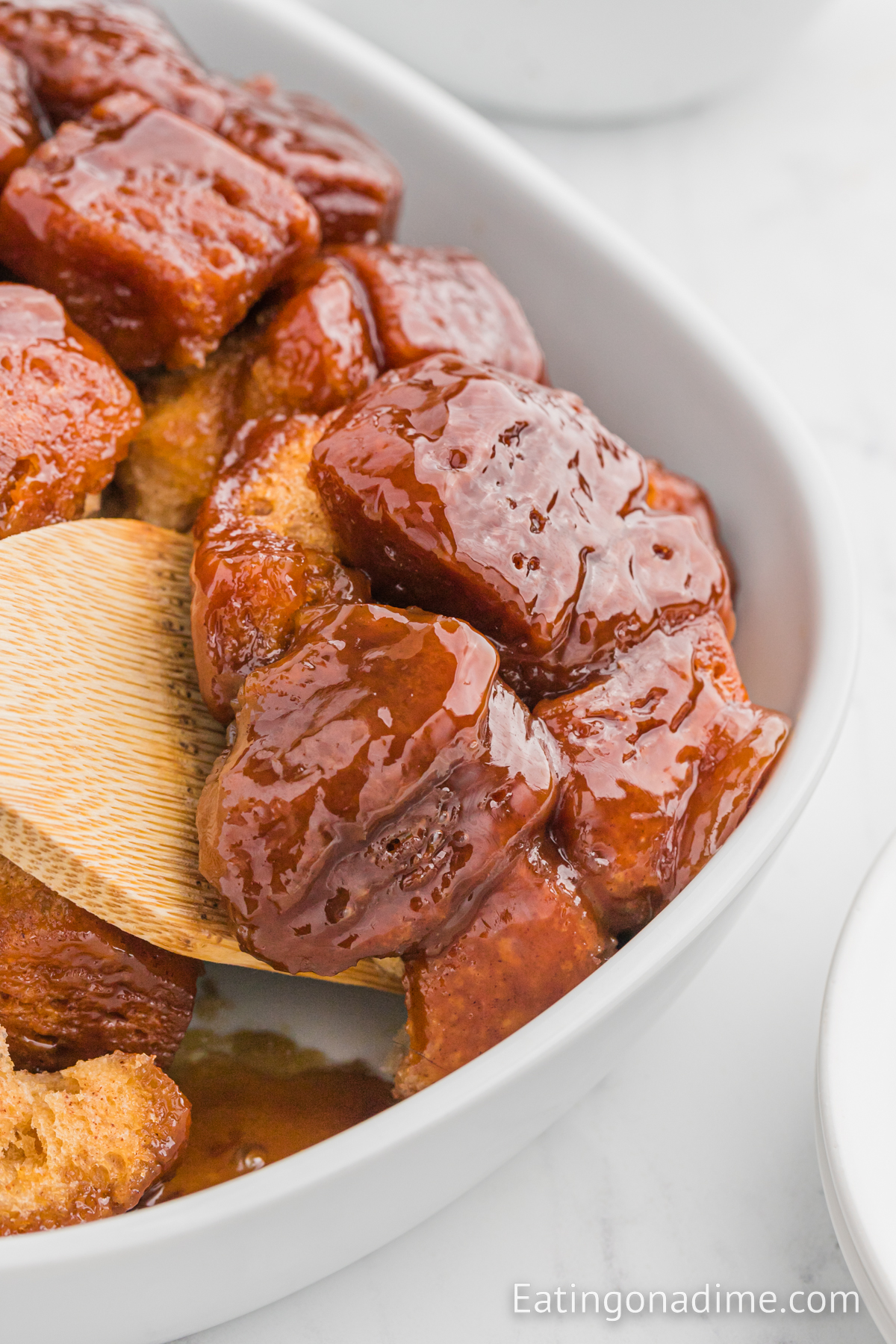 Monkey bread in a baking dish with a wooden spoon