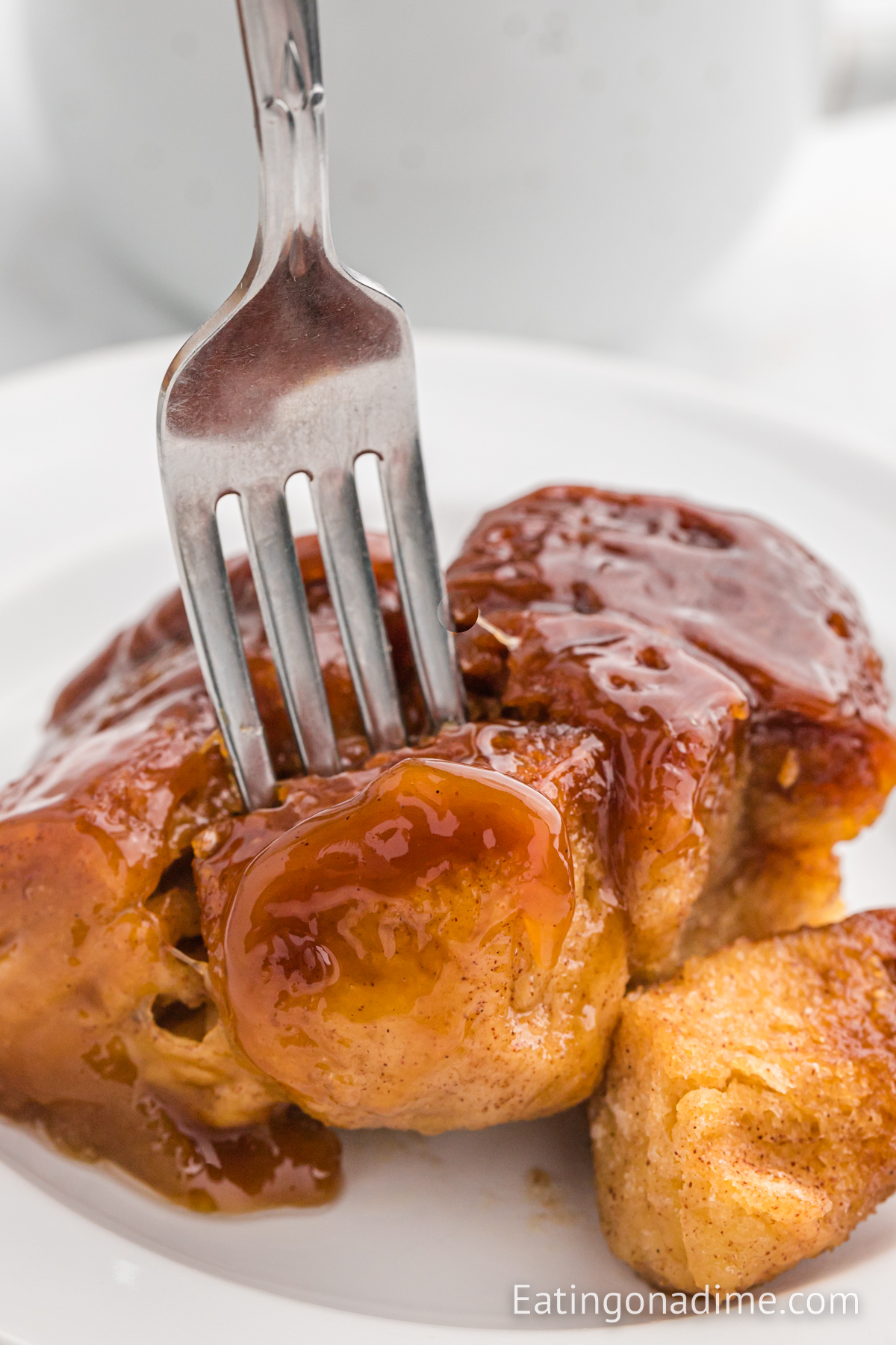 A serving of monkey bread on a white plate with a fork