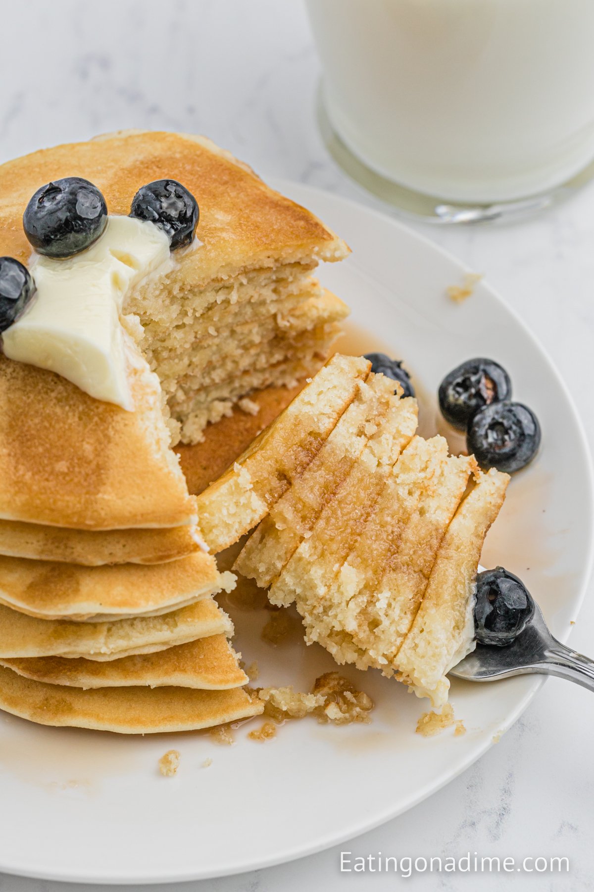 Sweet Cream Pancakes with butter, blueberries and syrup on the top