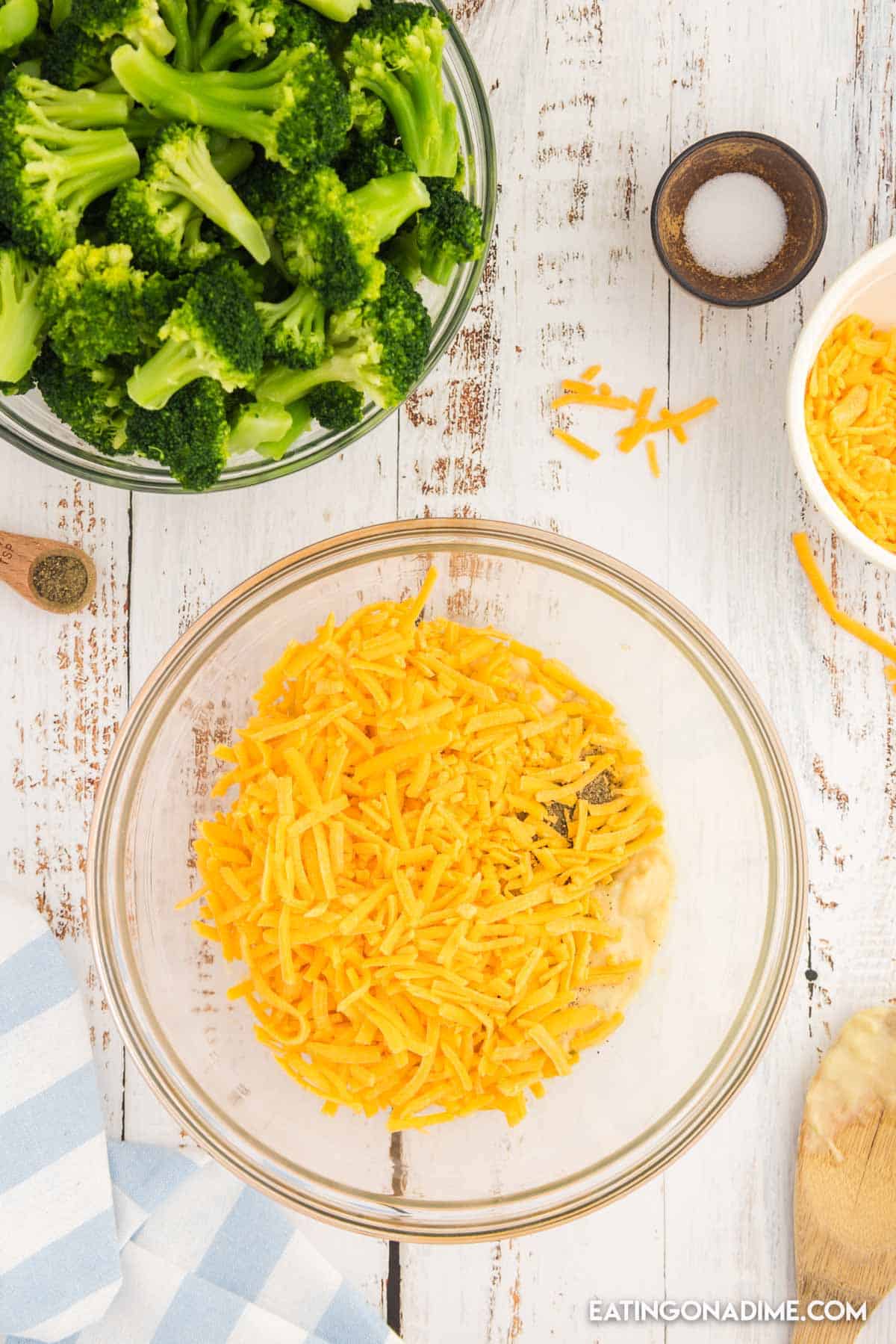 shredded cheese, celery soup, salt and pepper in a bowl