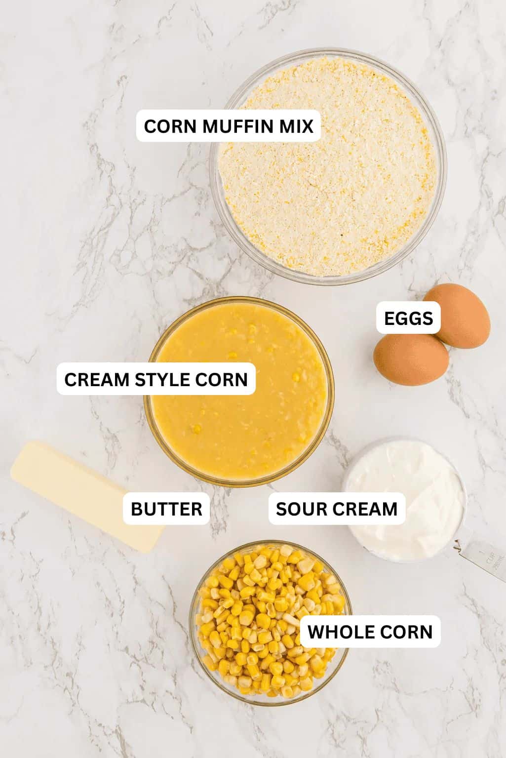 Ingredients needed for this recipe includes cornbread mix, cream style sweet corn, canned corn, salted butter, eggs, and sour cream.
