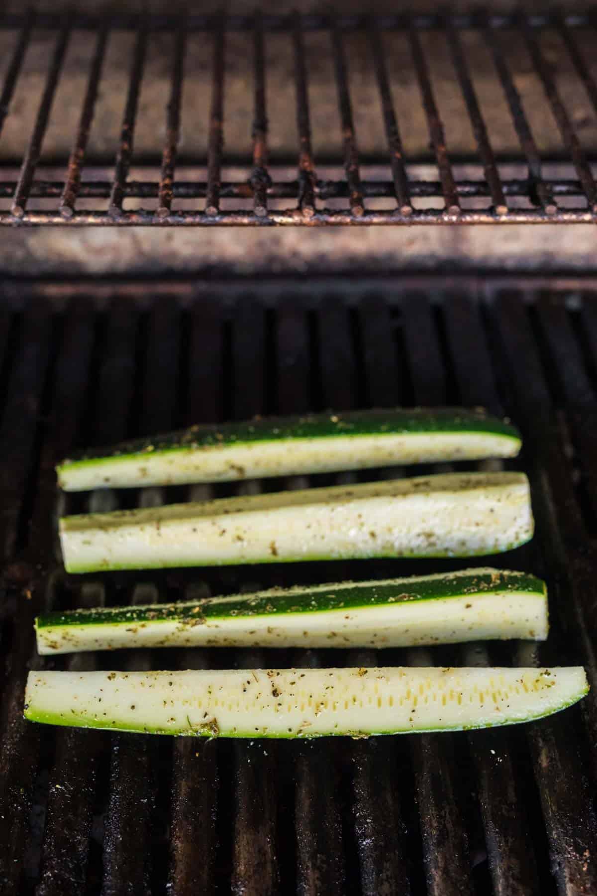 Zucchini spears placed on grill grates