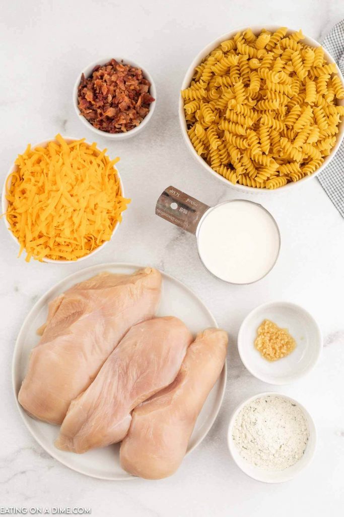 Ingredients needed - chicken breast, bacon, garlic, ranch dressing mix, heavy whipping cream, rotini pasta, cheddar cheese