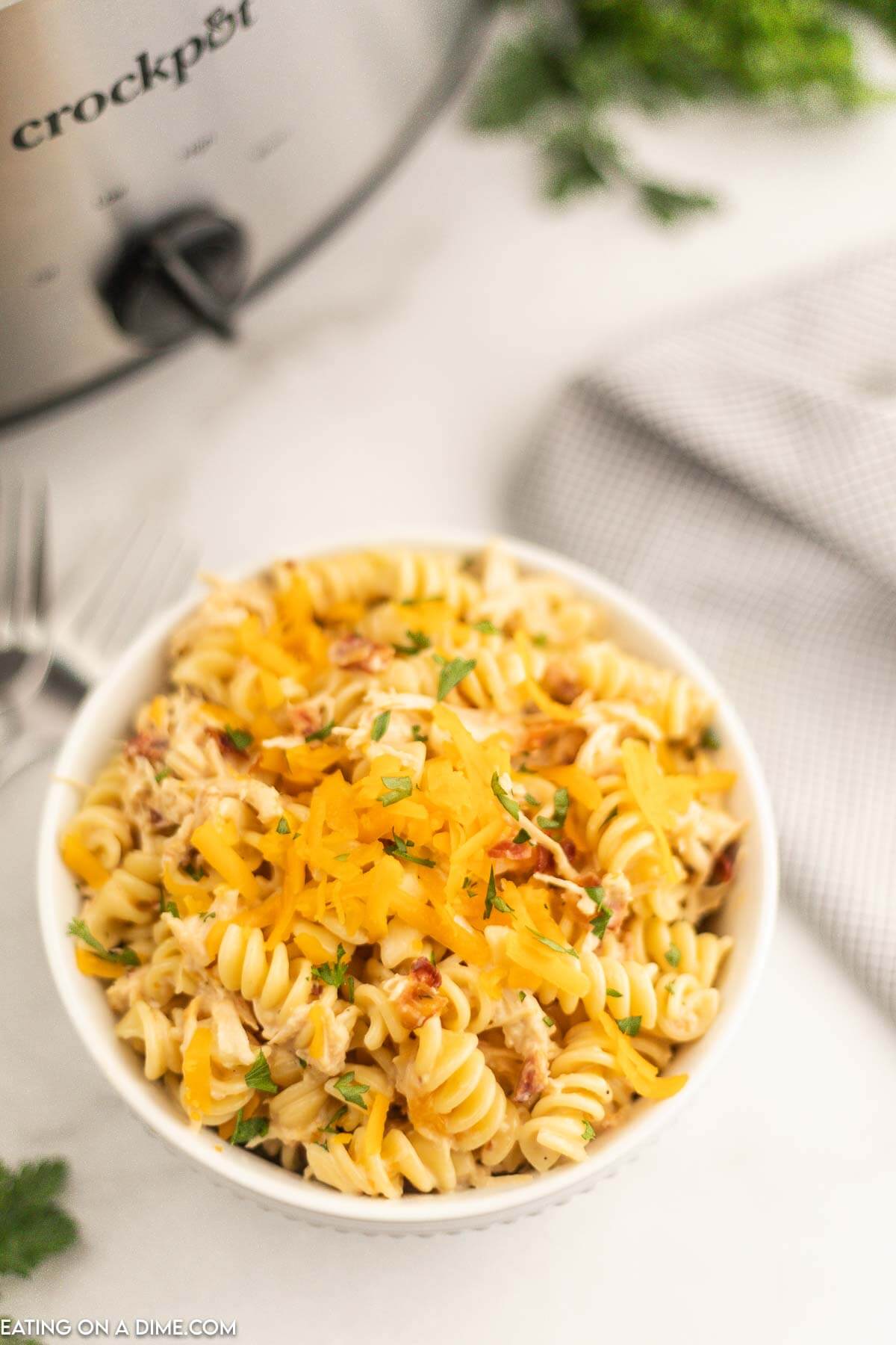 Chicken bacon ranch pasta in a bowl topped with cheddar cheese