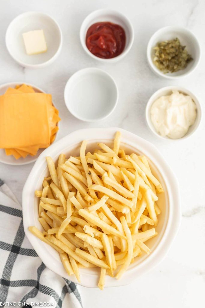 Ingredients needed - french fries, american cheese, white onion, butter, mayonnaise, ketchup, pickle relish, white vinegar