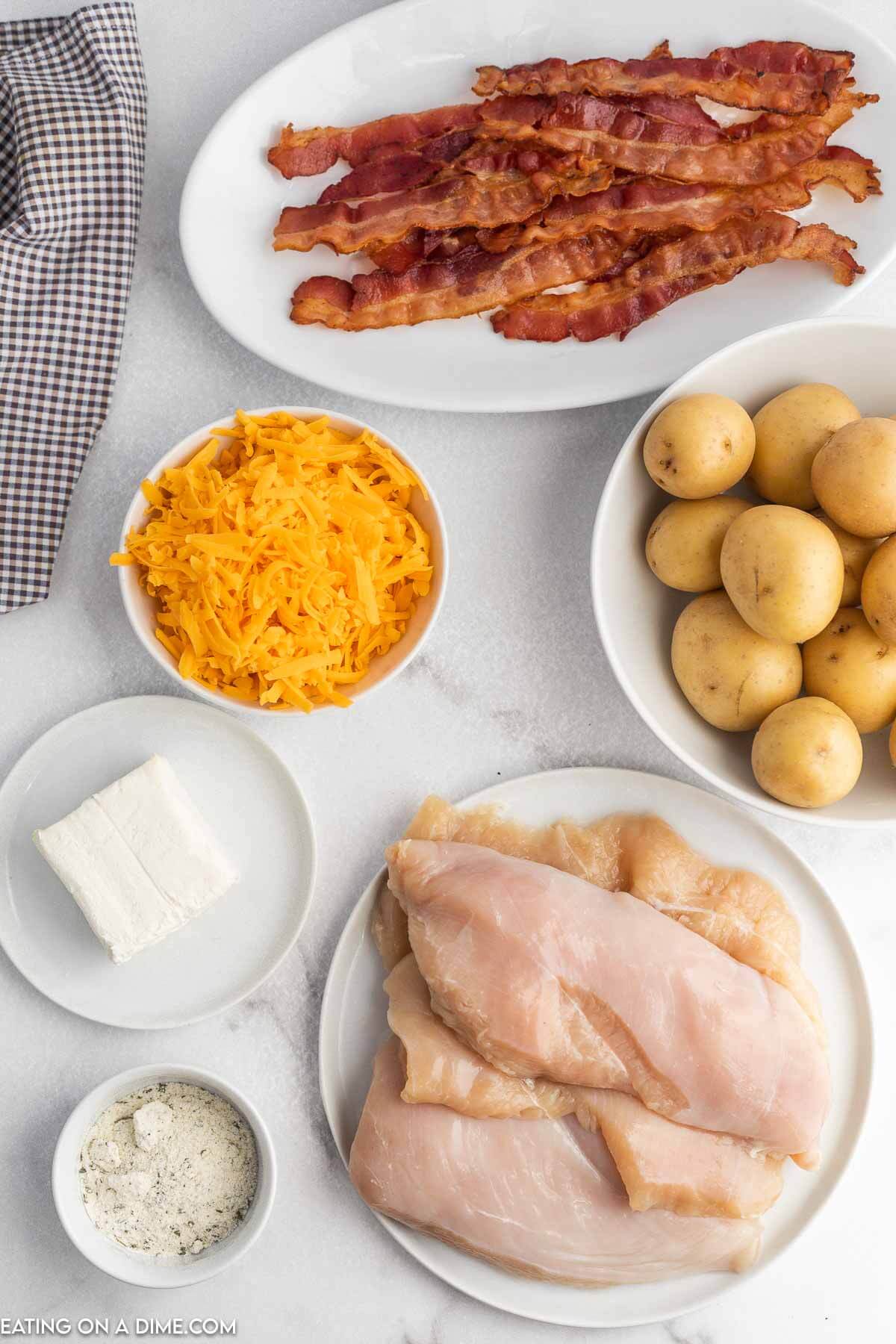 Ingredients for Crack Chicken Foil packet - cooked bacon, shredded cheese, small potatoes, cream cheese, ranch seasoning, chicken