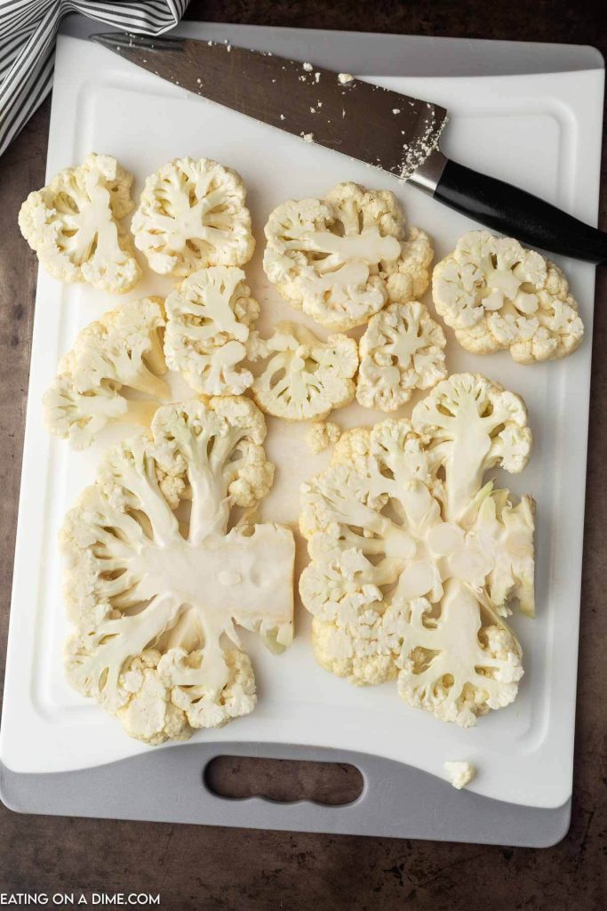Slices of cauliflower on cutting board. 