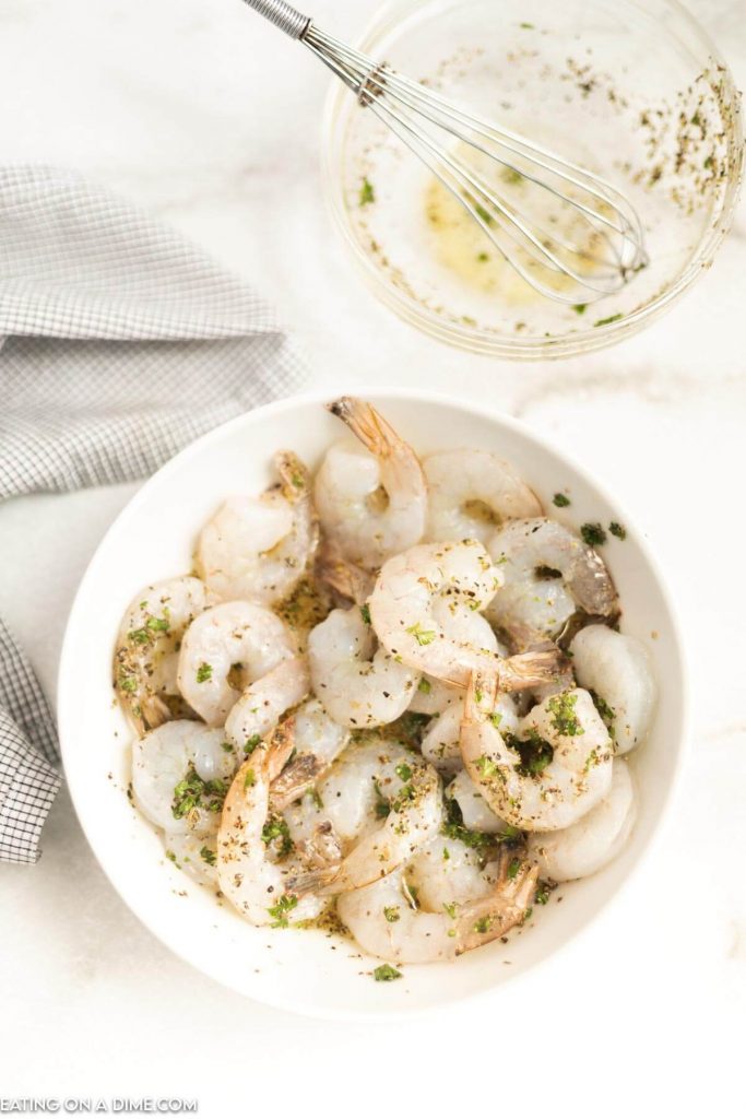 Shrimp in bowl with marinade. 
