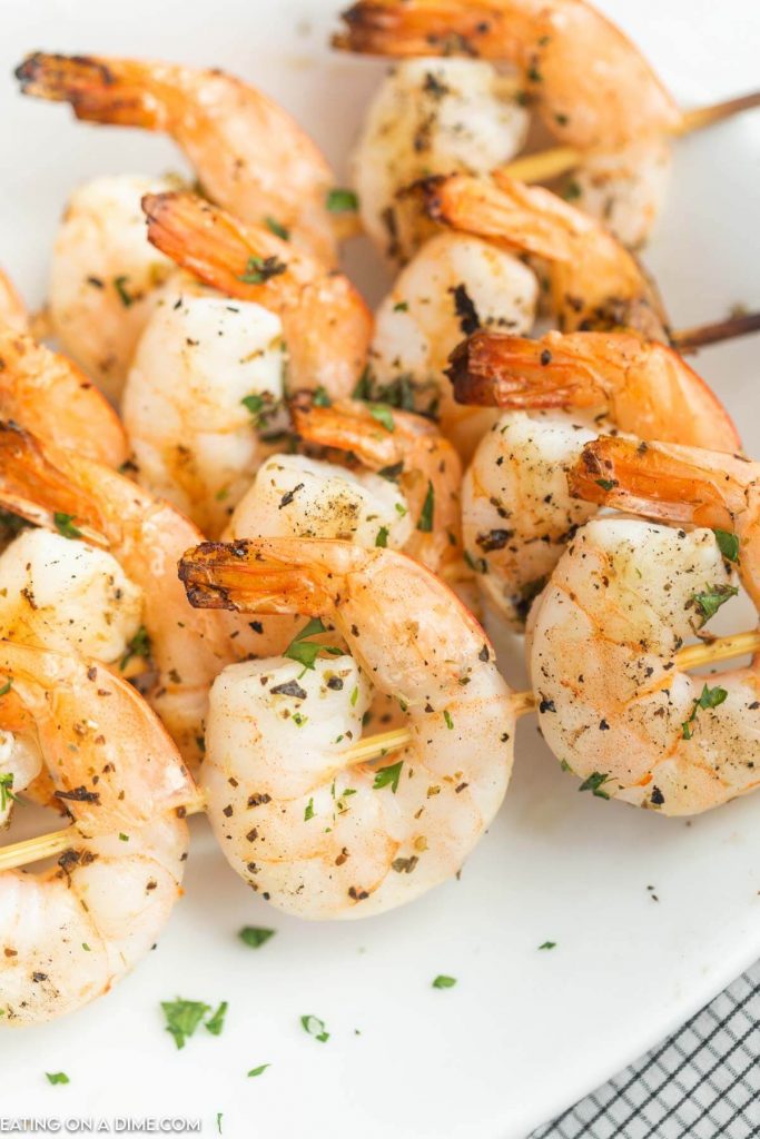 Grilled shrimp skewers on a platter. 