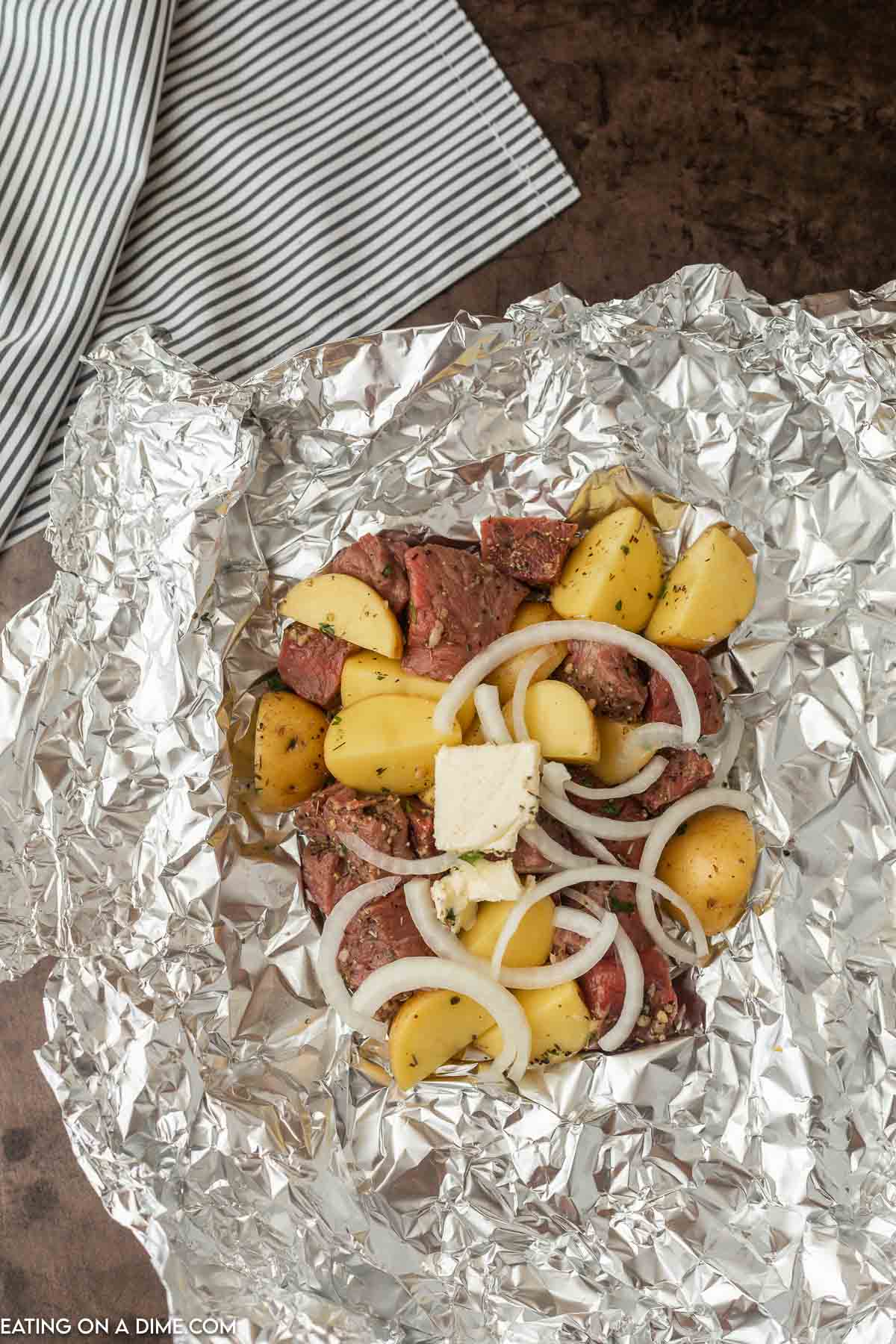 Ingredients being layered in foil. 