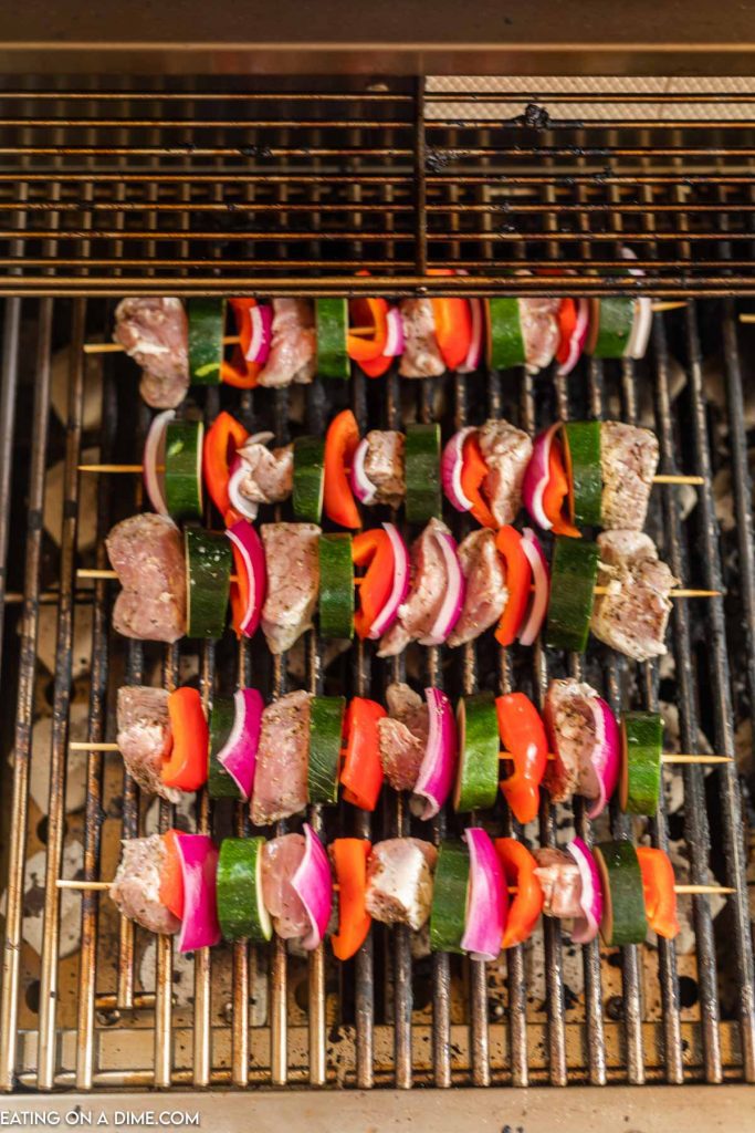 Kabobs on the grill grates. 