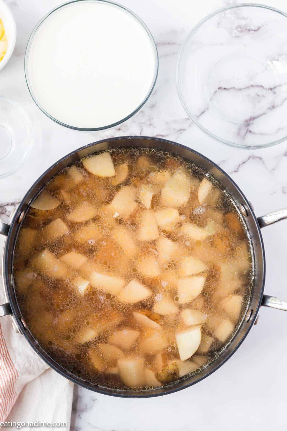 Diced potatoes in a large pot of water.