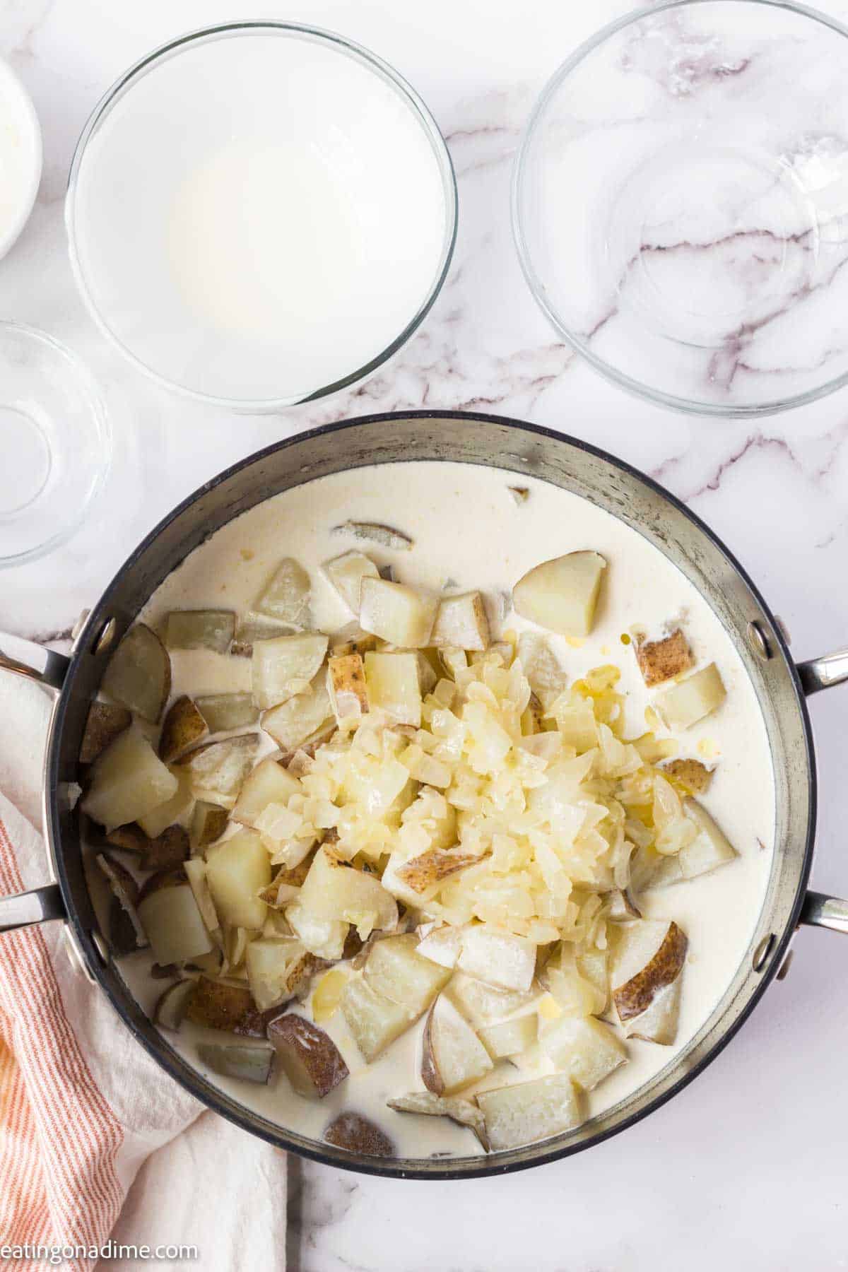 Cooked potatoes, chopped onion mixture and milk in a large pot.