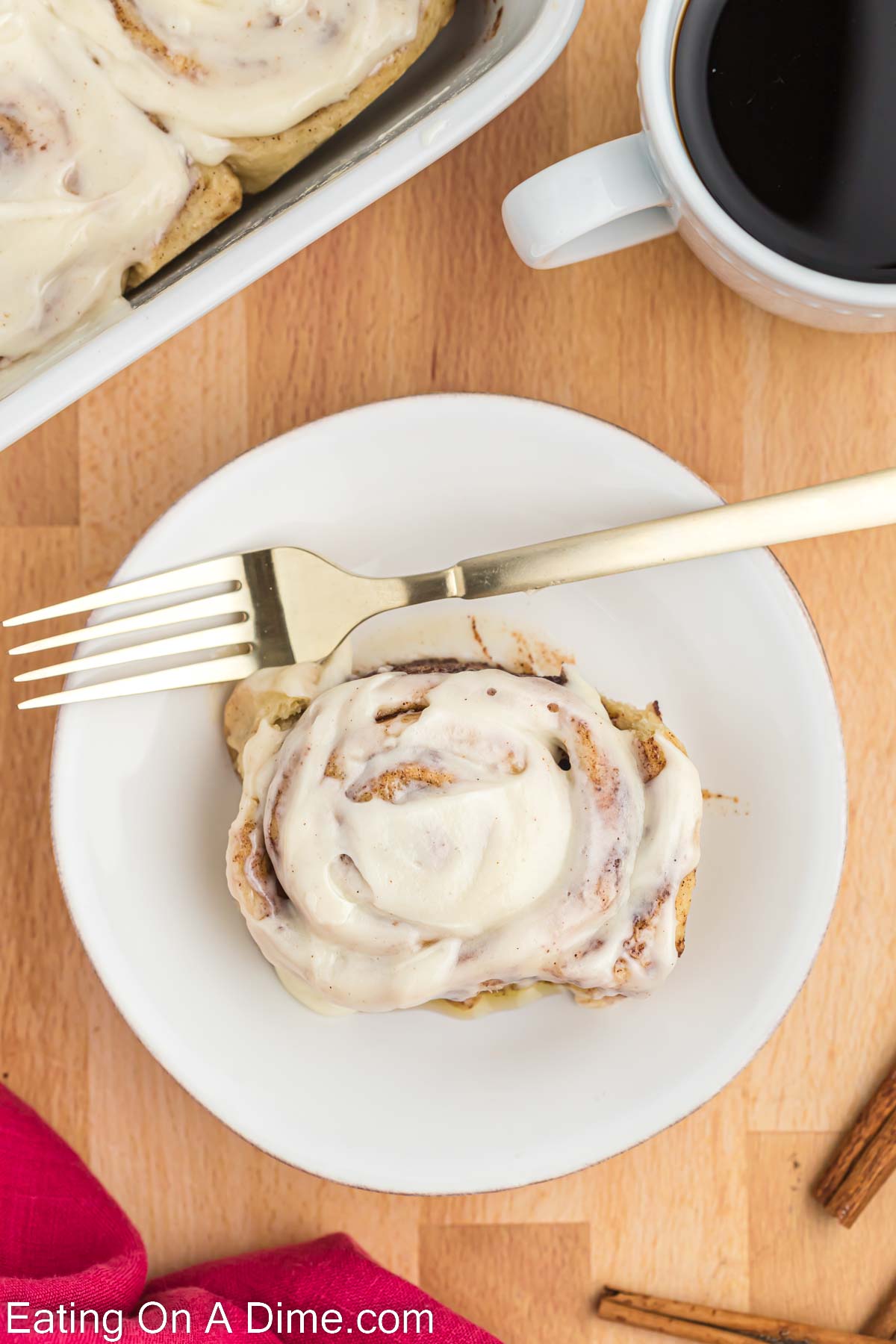 Cinnamon Roll on a white plate with a fork