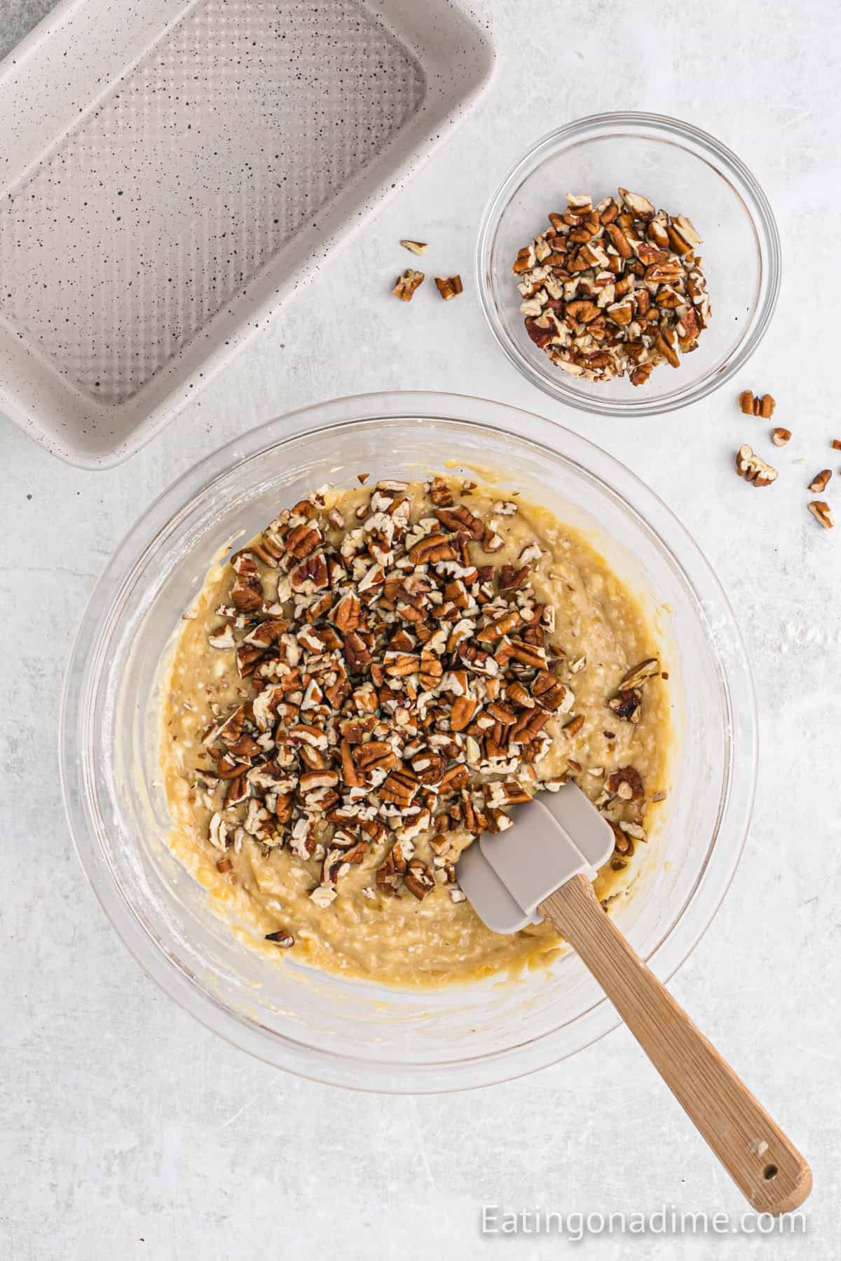 Pecans added to the bowl of the batter.