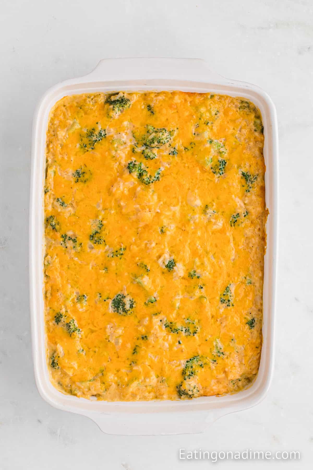 Broccoli and cheese casserole in a baking dish topped with melted cheese.