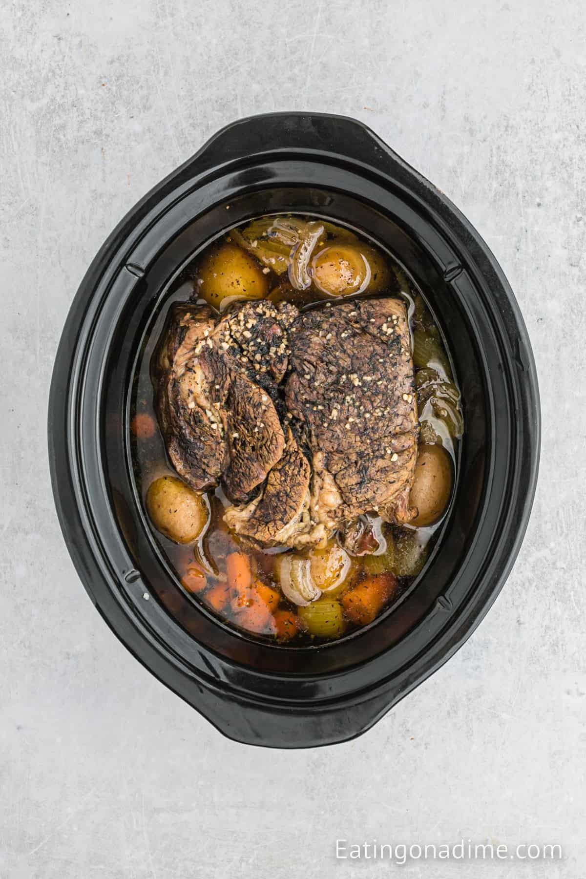 Cooked roast and vegetables in the slow cooker.