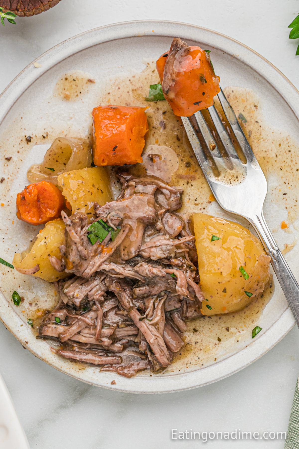 Shred Pot Roast on a plate with potatoes and carrots