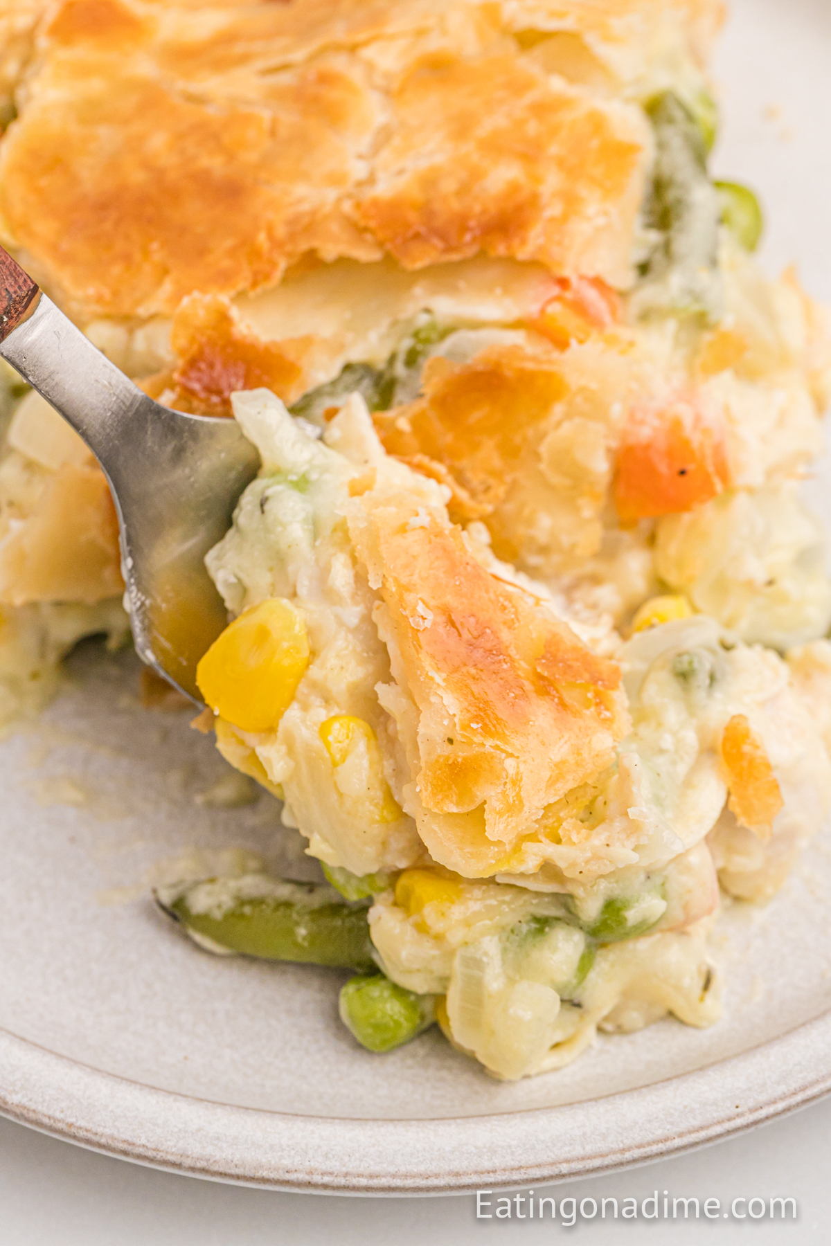Turkey Pot Pie on a plate with a bite on a fork