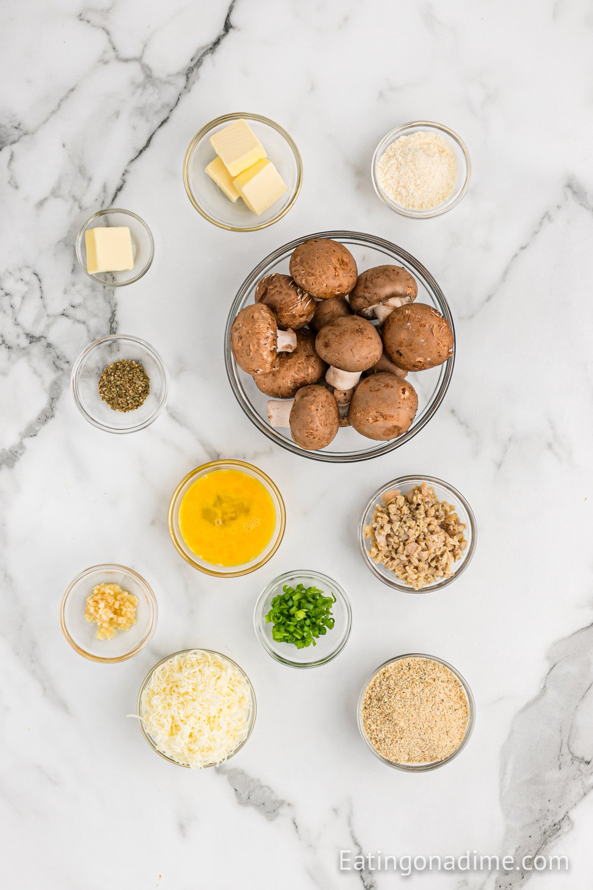 Ingredients needed - mushrooms, butter, mozzarella cheese, minced clams, green onion, egg, minced garlic, italian bread crumbs, oregano, butter, parmesan cheese