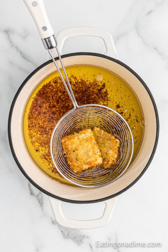 Frying ravioli in a sauce pan of oil