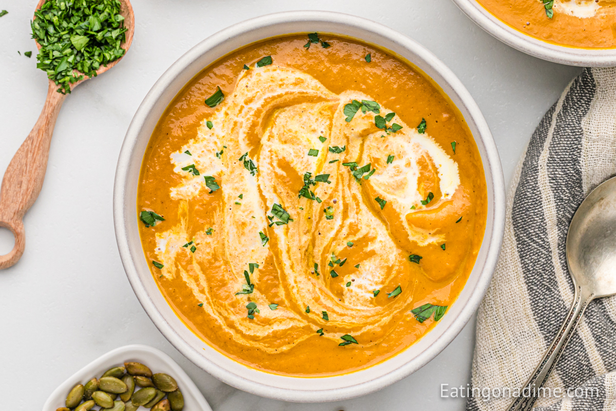 Close up image of pumpkin soup in a white bowl