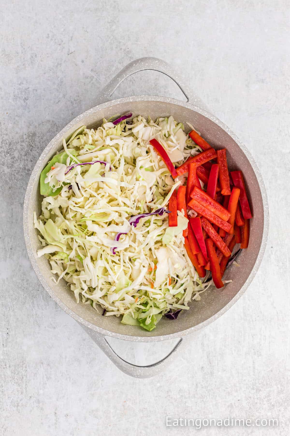Coleslaw mix and red bell peppers in a large skillet.