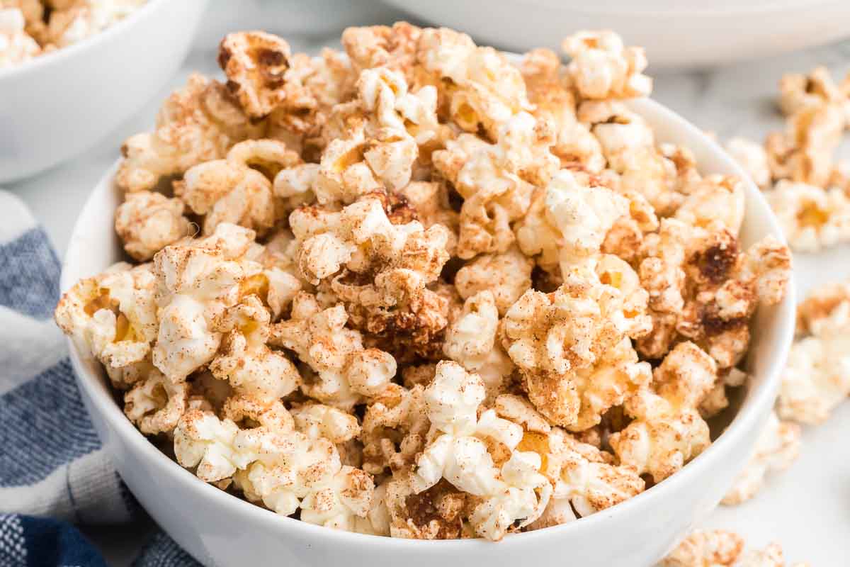 A white bowl of cinnamon toast crunch popcorn