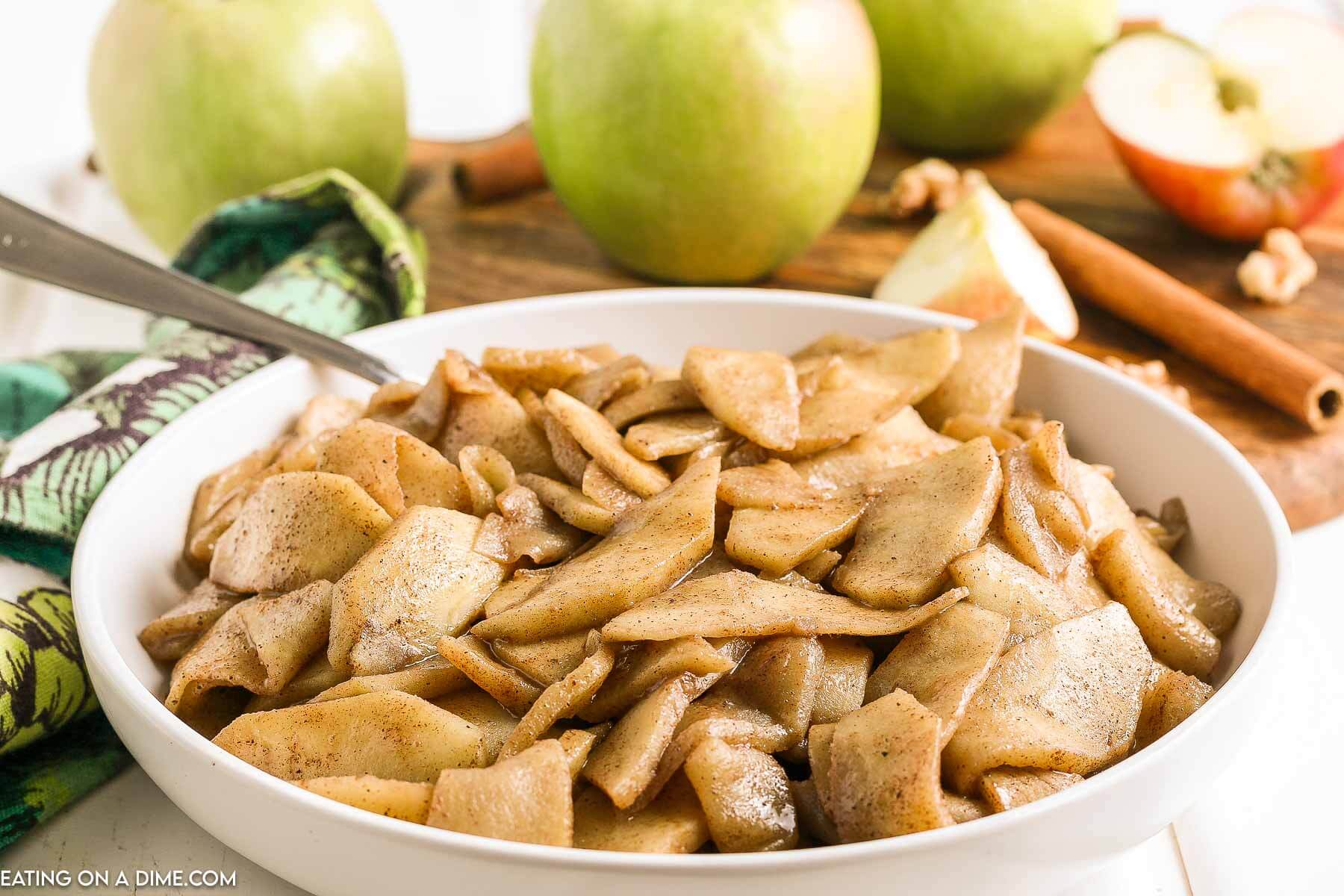 Fried Apples in a white dish with a spoon