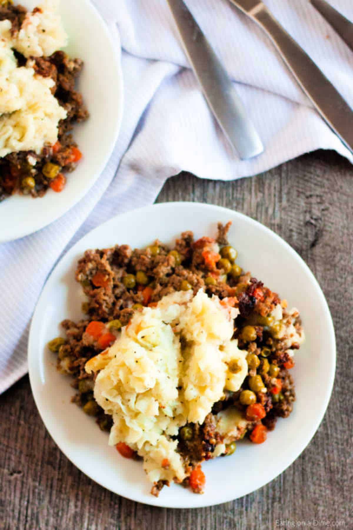 You can enjoy Crock Pot Shepherd's Pie Recipe any day of the week thanks to the slow cooker. This tasty recipe is so easy in the crockpot. Shepherd's Pie on a white plate