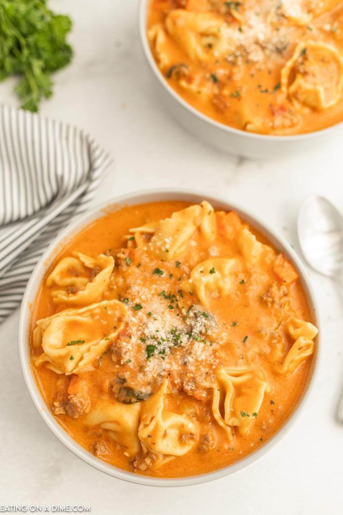 Close up image of creamy sausage tortellini soup in a bowl