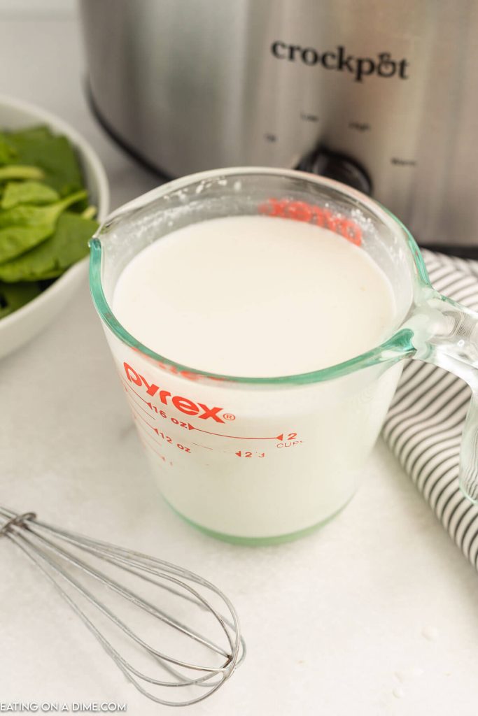a measuring cup with heavy cream in it