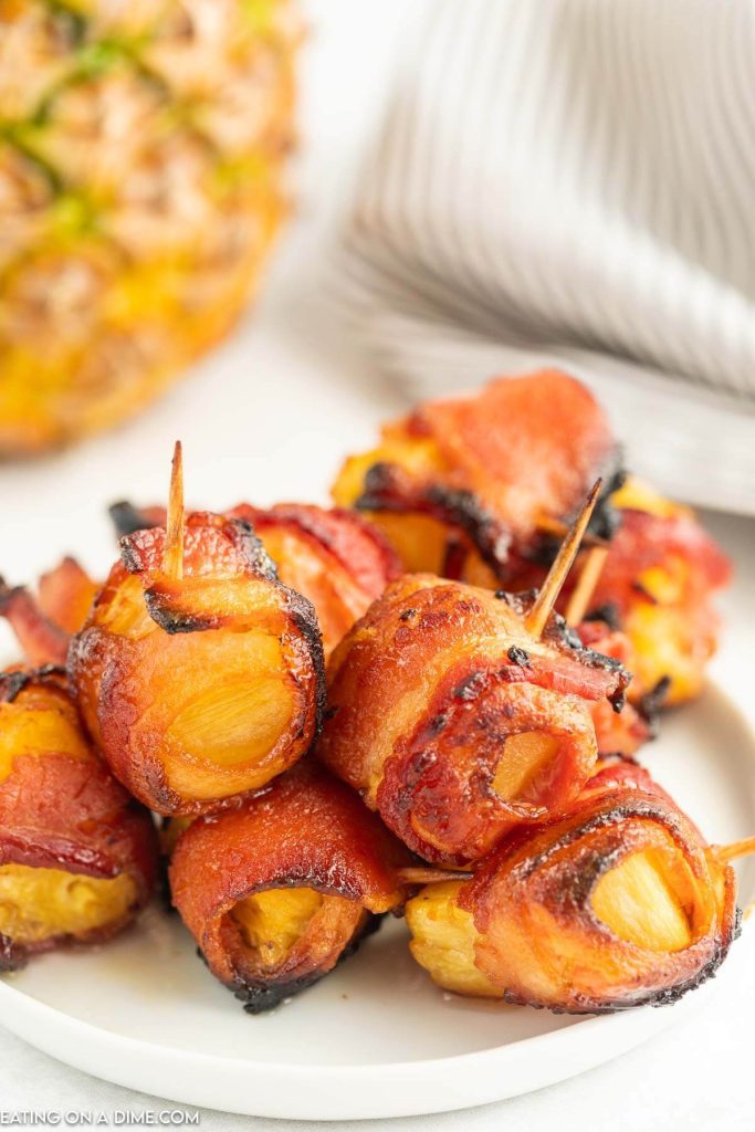 Bacon Wrapped Pineapple Bites on a white plate